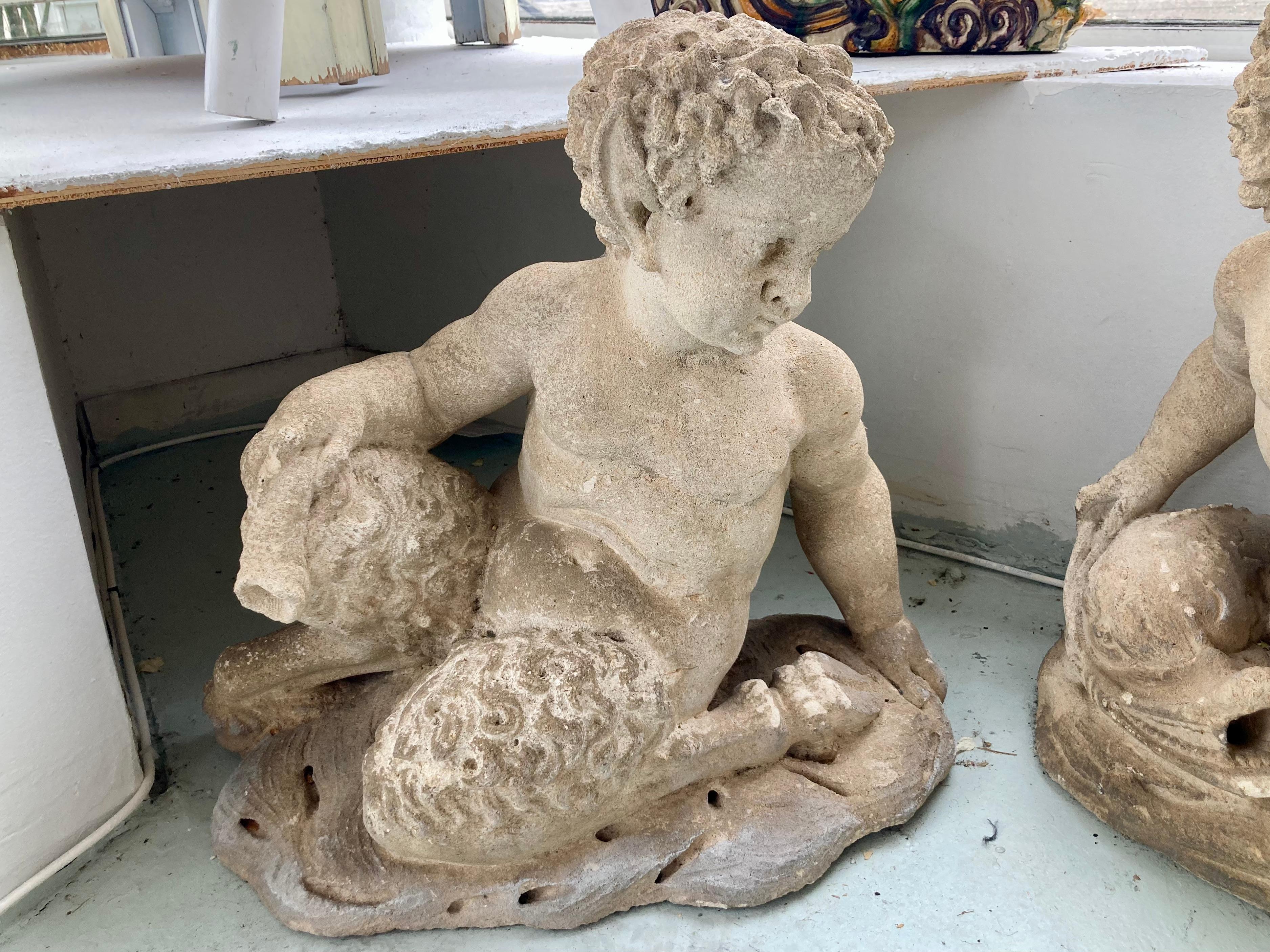 Pair of French carved stone Putti and Pan garden statues. See our collection of garden statues featuring Pan and Putti in our inventory.