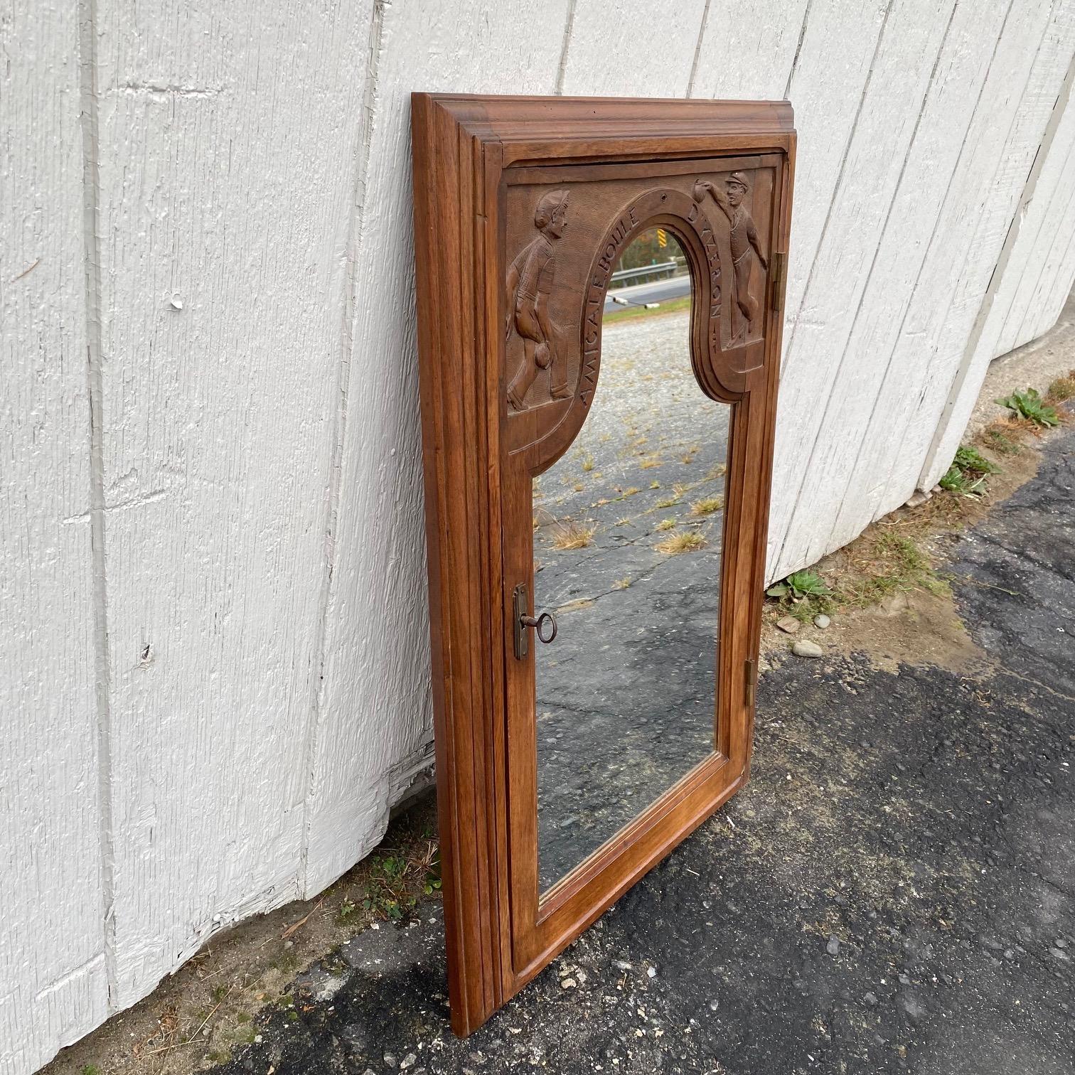 From France, fabulous and unusual mirror made from a carved walnut boule tournament score board cabinet. Translates to: 