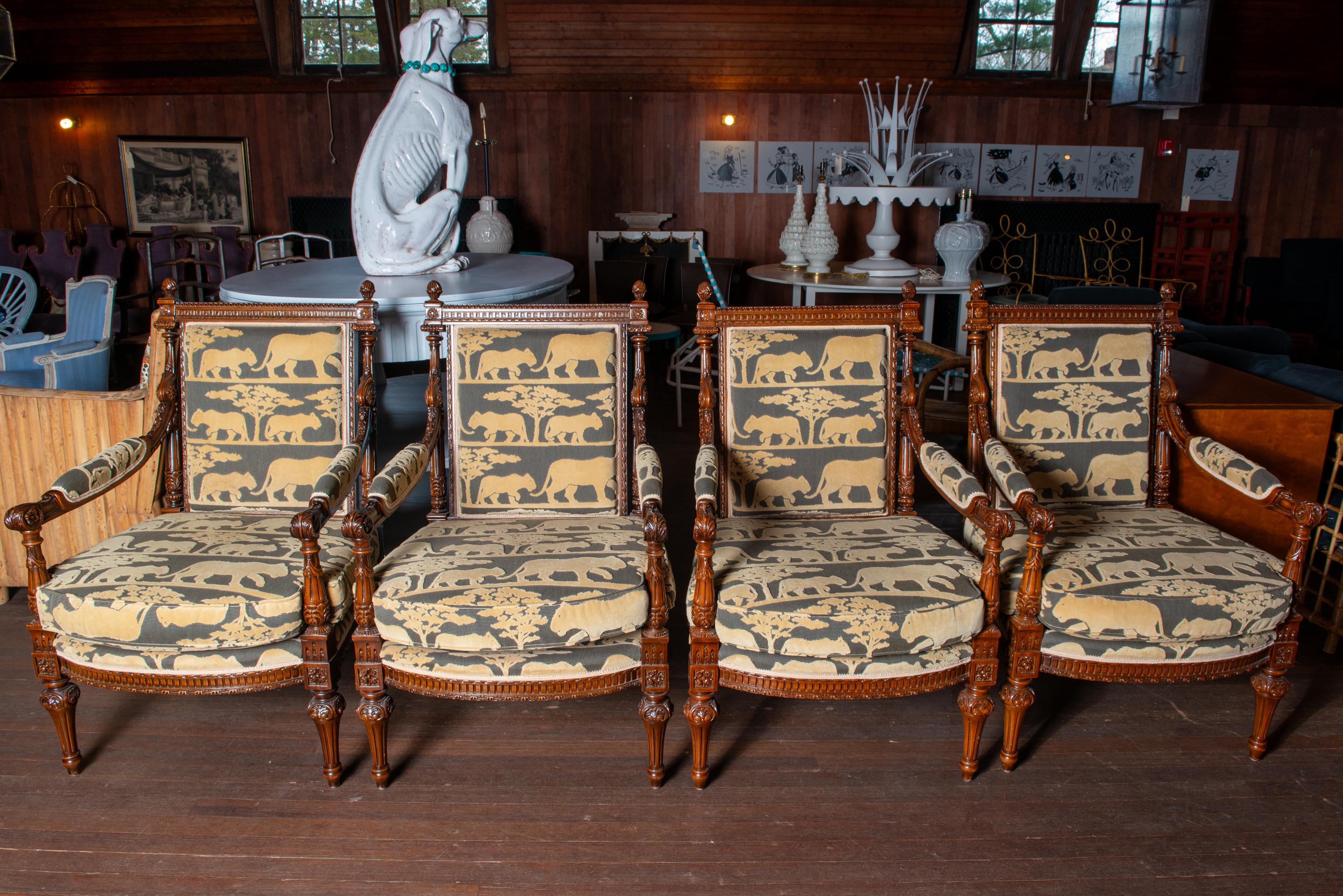 Four French style walnut arm chairs with intricate carved wood details. Upholstered in luxurious velvet fabric depicting silhouetted large cats and umbrella thorn trees on the Serengeti. Chairs sold as a pair. Or buy all four. 