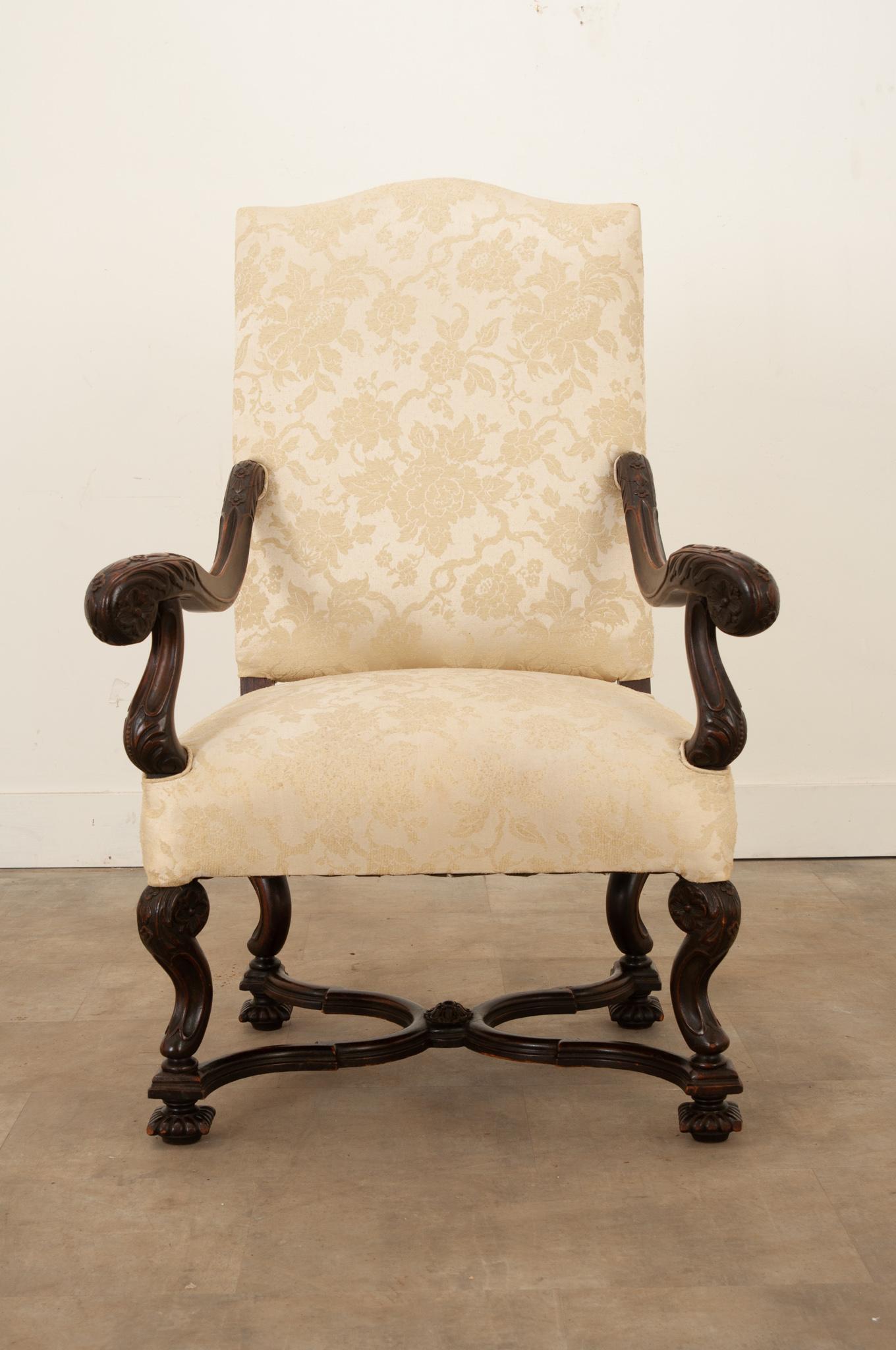 A single French Os de Mouton armchair, with wonderfully carved details. The large armchair is comfortable and upholstered in a gently used silk Damask fabric. These timeless armchairs have a design that lends themselves to a variety of decors,