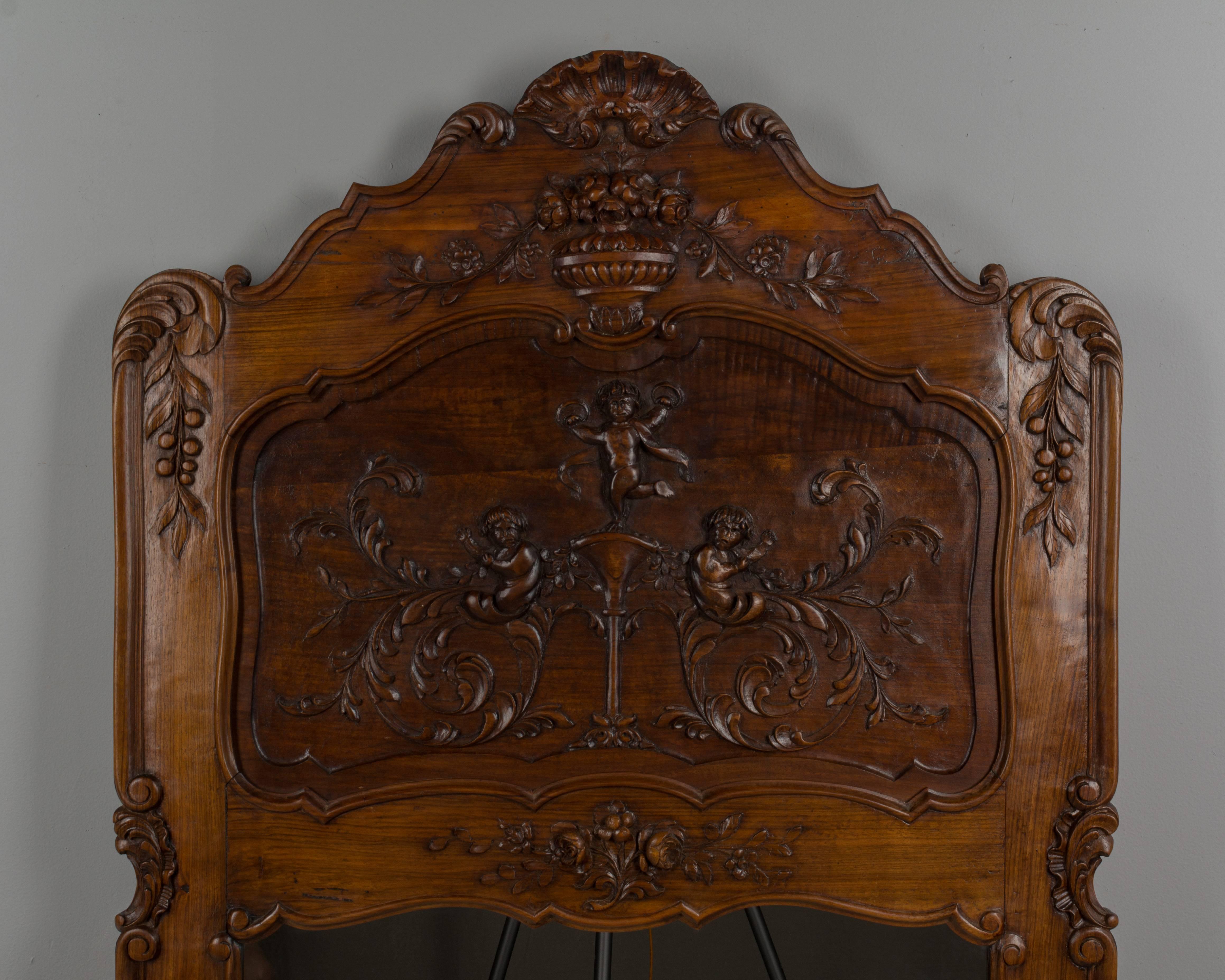 A French Provençal Louis XV Style walnut trumeau mirror with fine hand carvings. All original. Please refer to photos for more details. We have a large selection of French antiques at Olivier Fleury, Inc.  Please visit our showroom in Winter Park,
