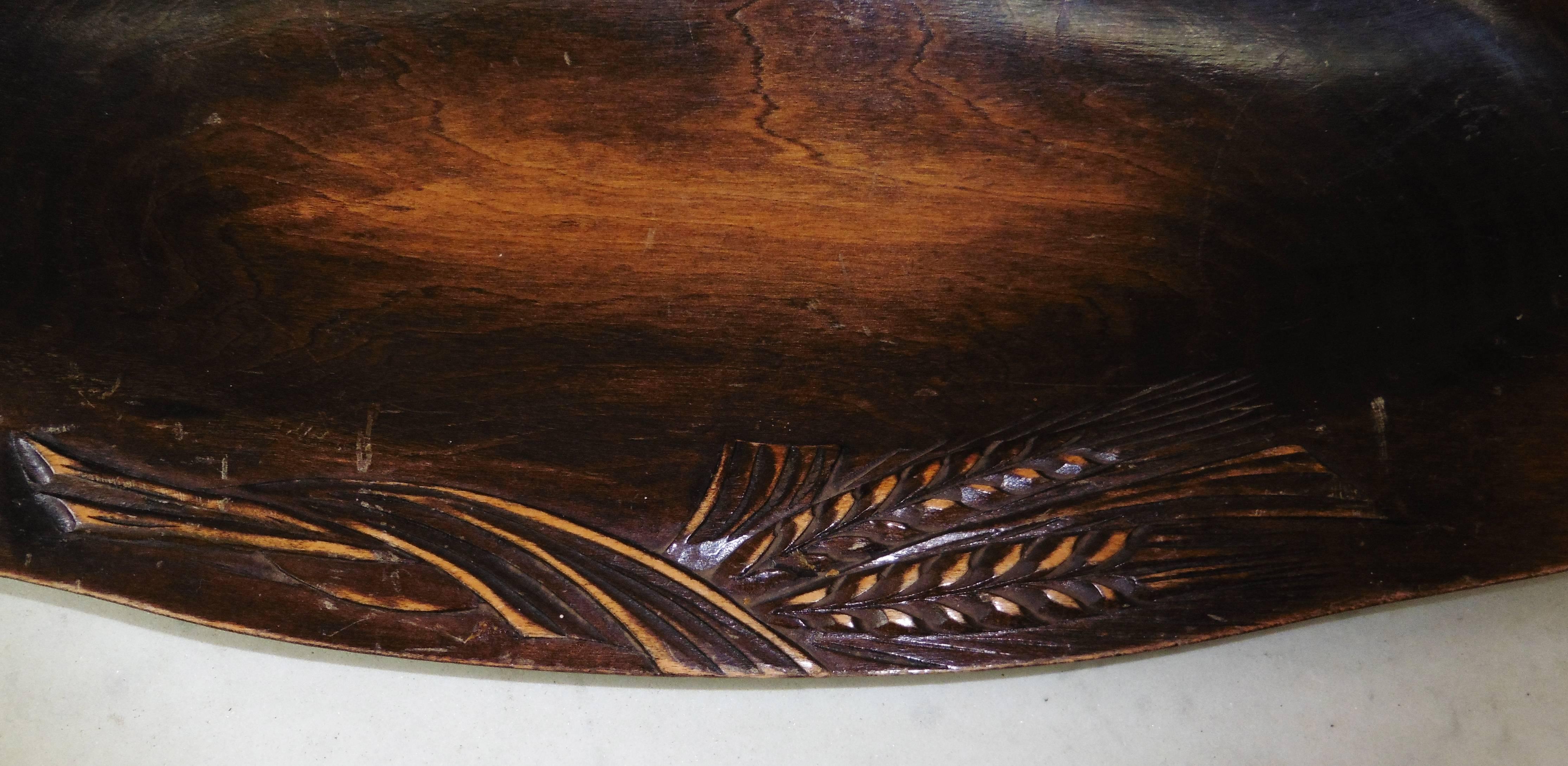 Large French oval carved oak bread platter with wheat-motif border.