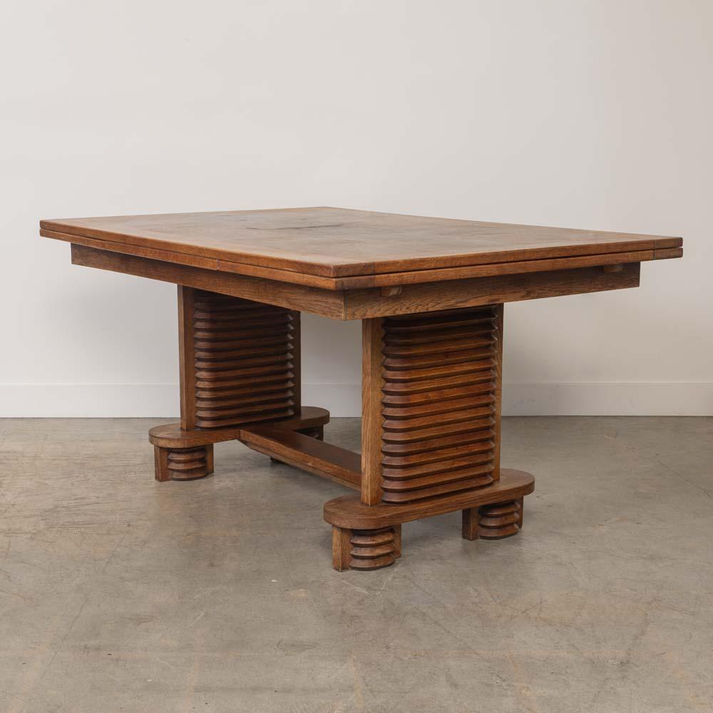Unglaublicher Holztisch von Charles Dudouyt, hergestellt in Frankreich, 1940er Jahre. Große rechteckige Parkettplatte mit dicken, kunstvoll geschnitzten Holzbeinen auf einem Sockel. Originallackierung zeigt schönes Alter und Patina. Der Tisch misst