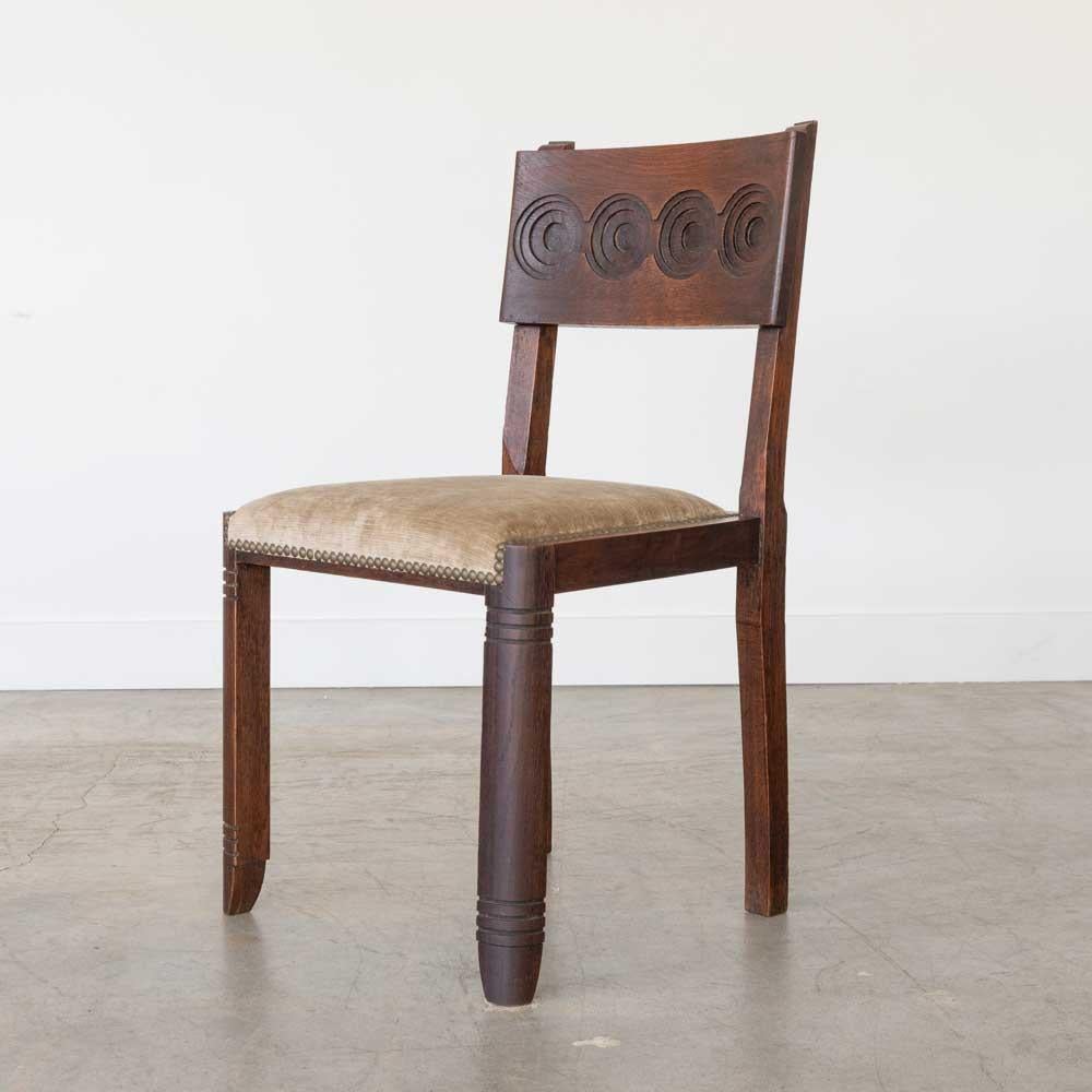 Great carved wood chair by Charles Dudouyt from France, 1940's. Carved legs with beautiful carved circle design on back. Newly upholstered brown chenille seat. Original dark wood finish is in great vintage condition with some imperfections and age
