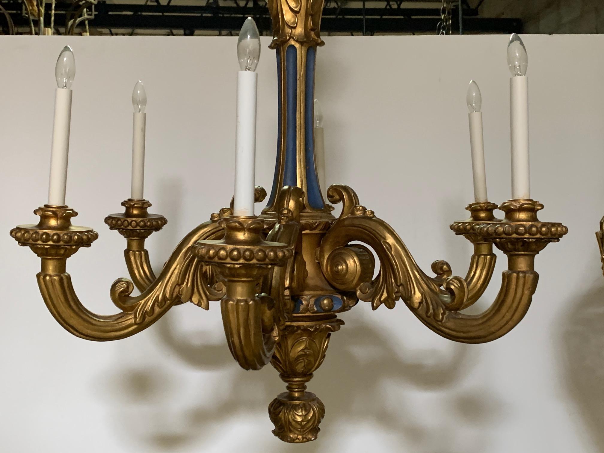 French Louis XVI style carved wood six-light chandelier with a gold leaf and blue painted finish. The chandelier dates from the early 20th century and appears to have been gilded and painted at a later date. The finish is beautiful with a wonderful