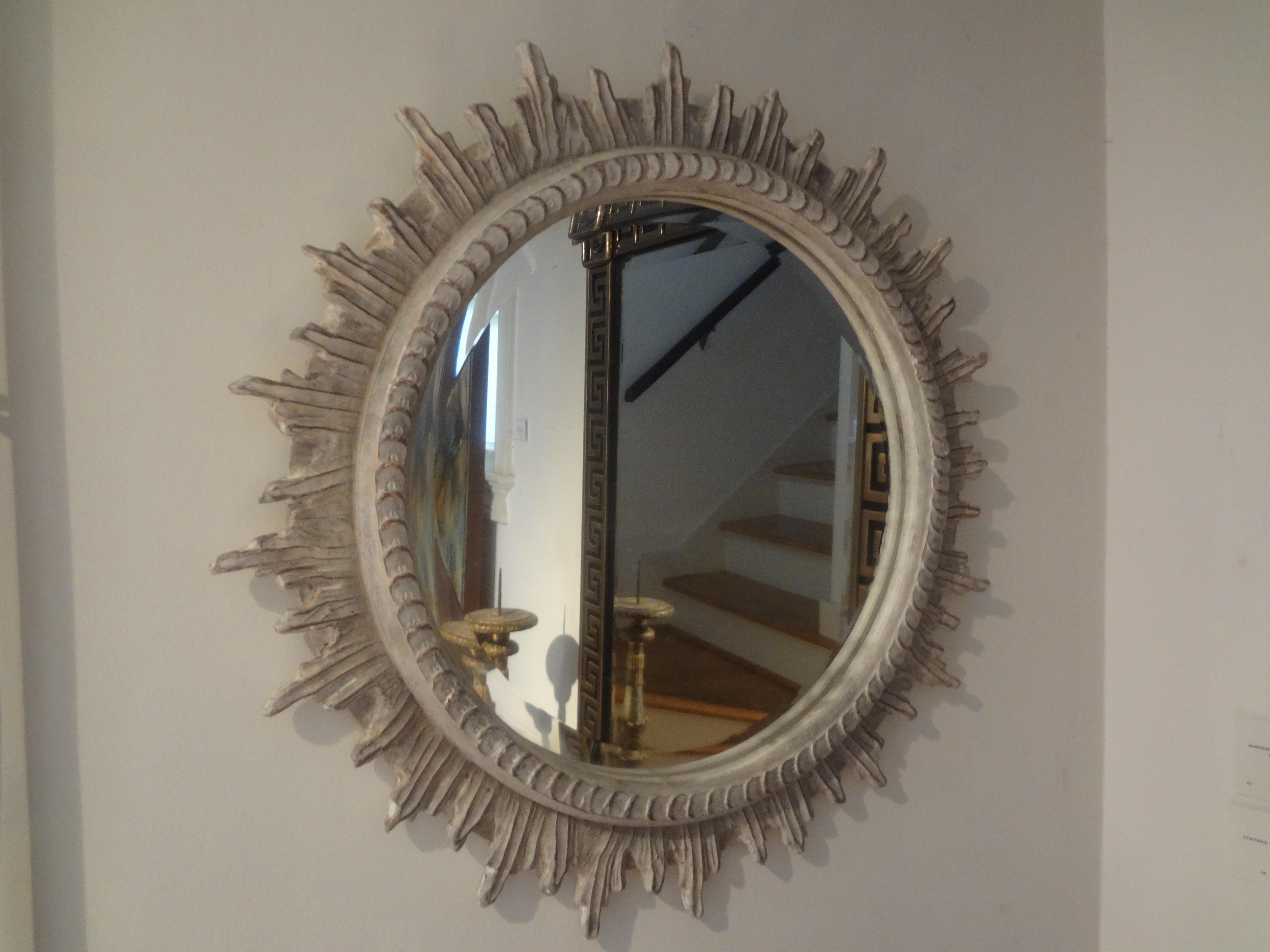 French carved wood paint decorated beveled sunburst mirror. Our midcentury French sunburst mirror is painted a cream/grey neutral color.