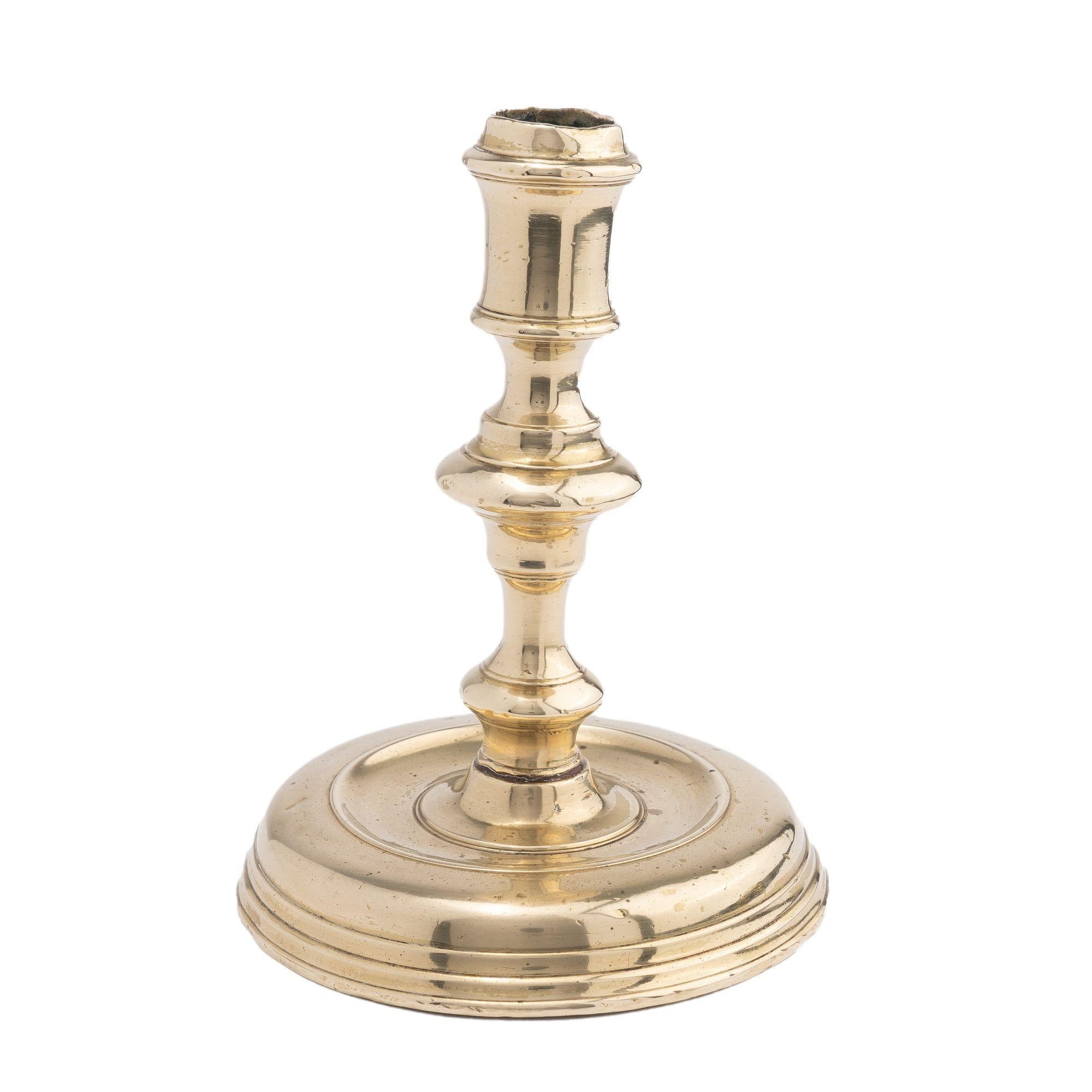 Cast brass baluster shaft & candle cup candlestick threaded to a circular base

France, circa 1720.