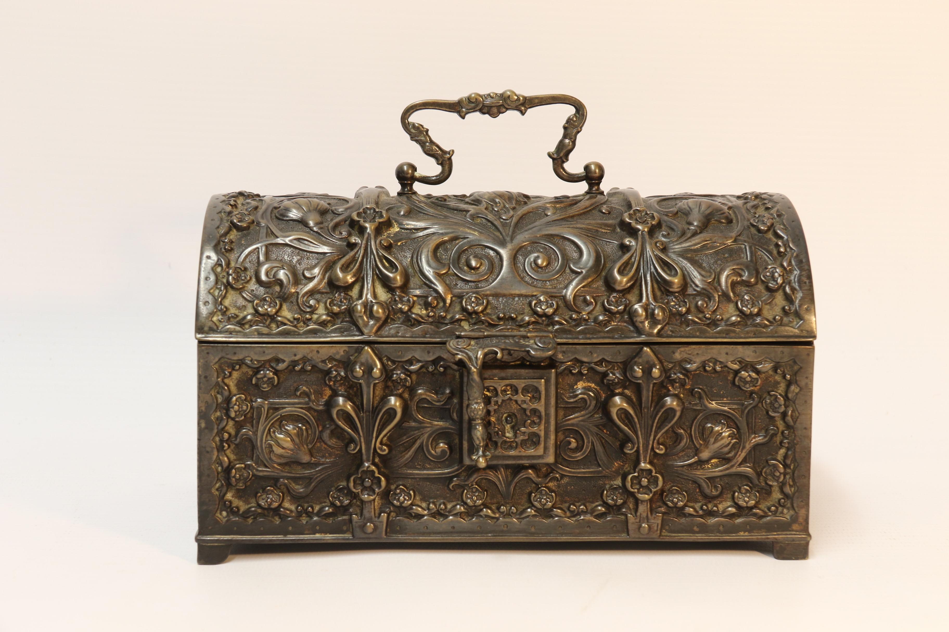 This heavily cast bronze jewelry box was made in France in the late 19th century and is made in the form of a medieval domed topped coffer.
It is superbly detailed with flowers and decorative strapwork cast with deep relief.
It has a carrying