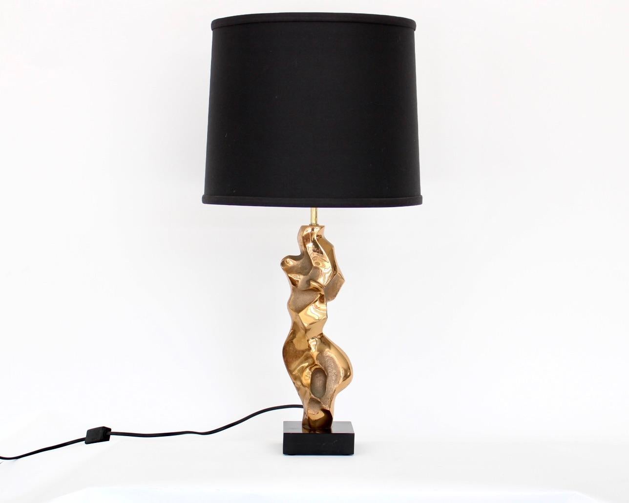 French cast bronze sculptural table lamp, signed M Jaubert, France, circa 1960-1970
Composed of a cast abstract bronze sculpture on a black marble base.
Signed near bottom on bronze.
Signs of vintage use on base. 
This shade can be included in the