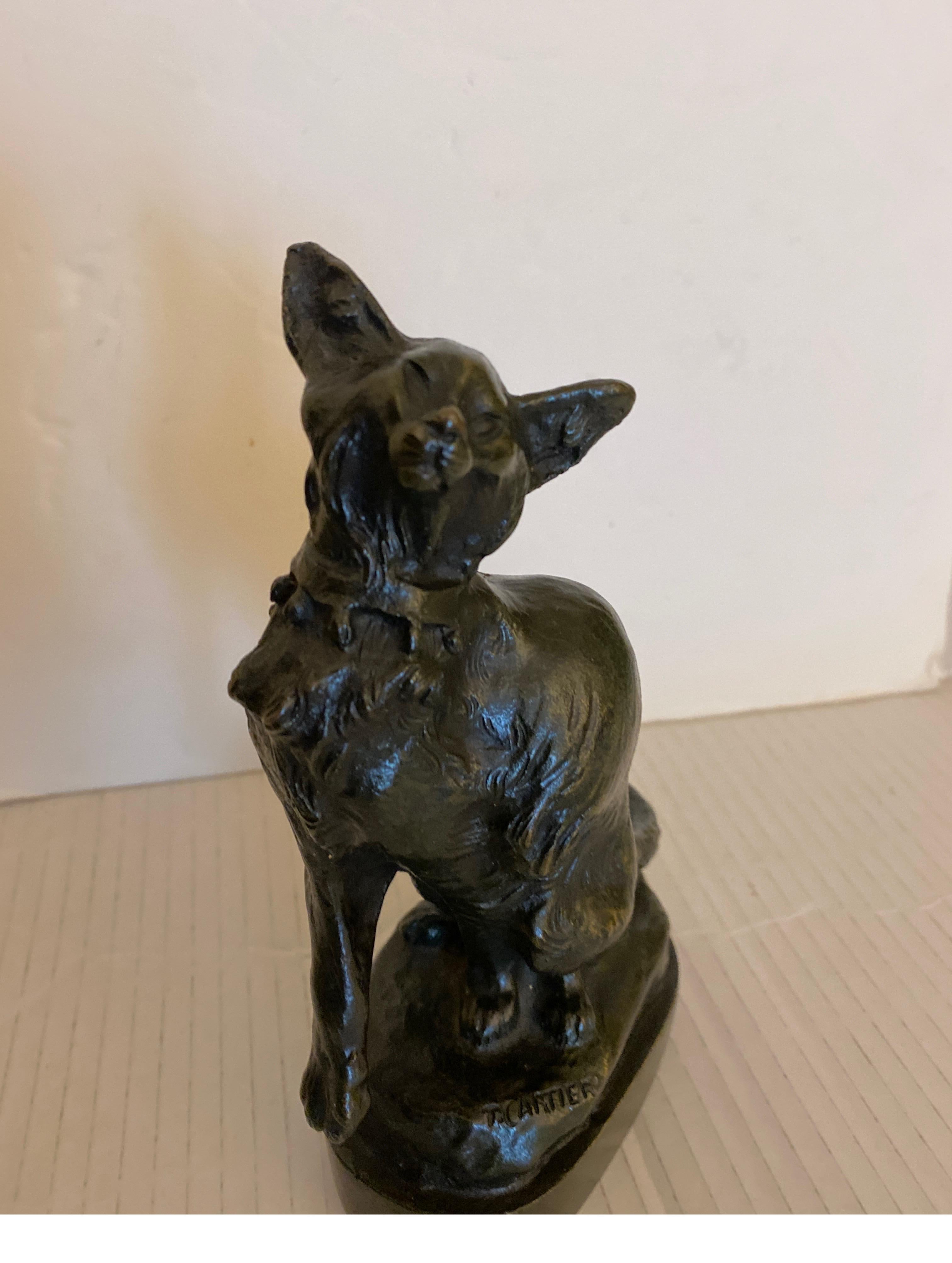 A small patinated cast bronze sculpture of a cat by Thomas Cartier (1879-1943), Signed on front and back at base. 6.5 inches tall 
Born in Marseilles in February of 1879, Thomas Francois Cartier was an animalier best known for his small bronze