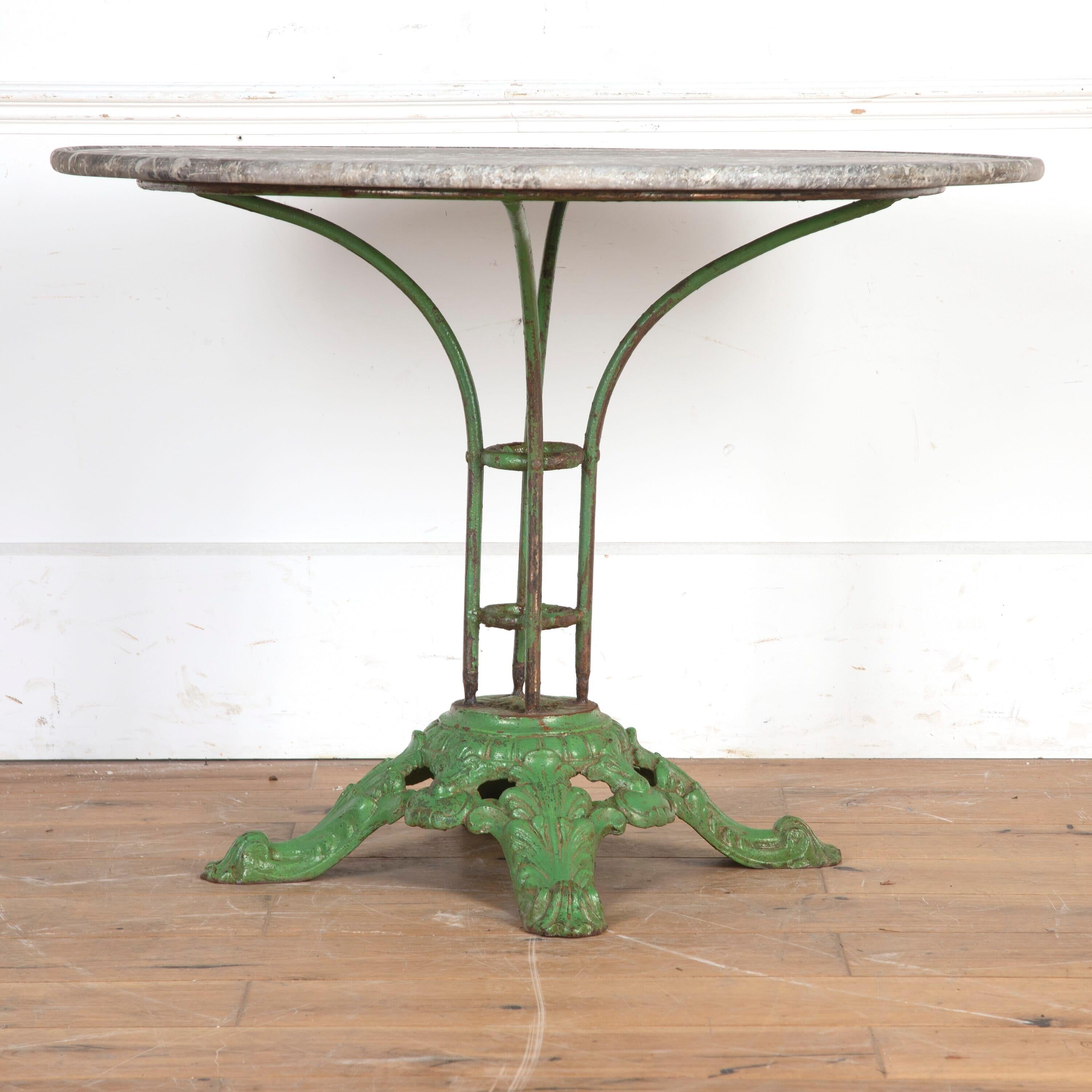 Wonderful French cast iron and marble garden table, circa 1900.

This striking table features a stunning circular thick marble top in grey with attractive white dappling. 

The top is supported on four central cast iron supports connected by