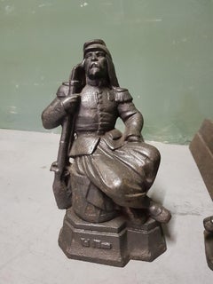 French Cast Iron Andirons with Persons Sitting on a Drum, Early 20th Century