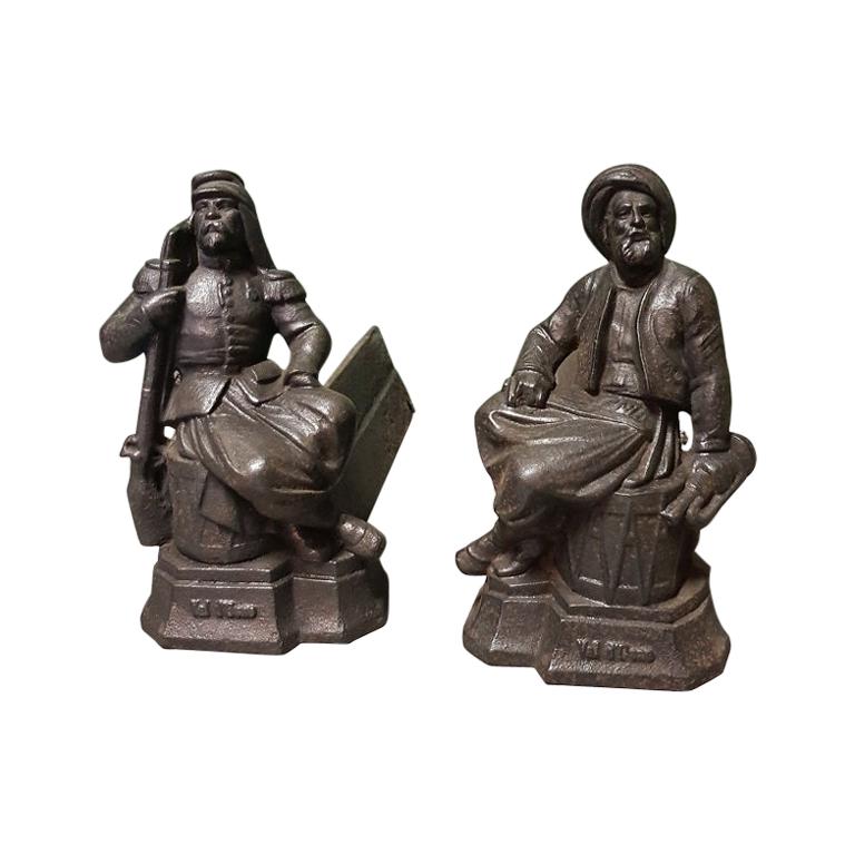 French Cast Iron Andirons with Persons Sitting on a Drum, Early 20th Century For Sale