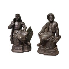 French Cast Iron Andirons with Persons Sitting on a Drum, Early 20th Century
