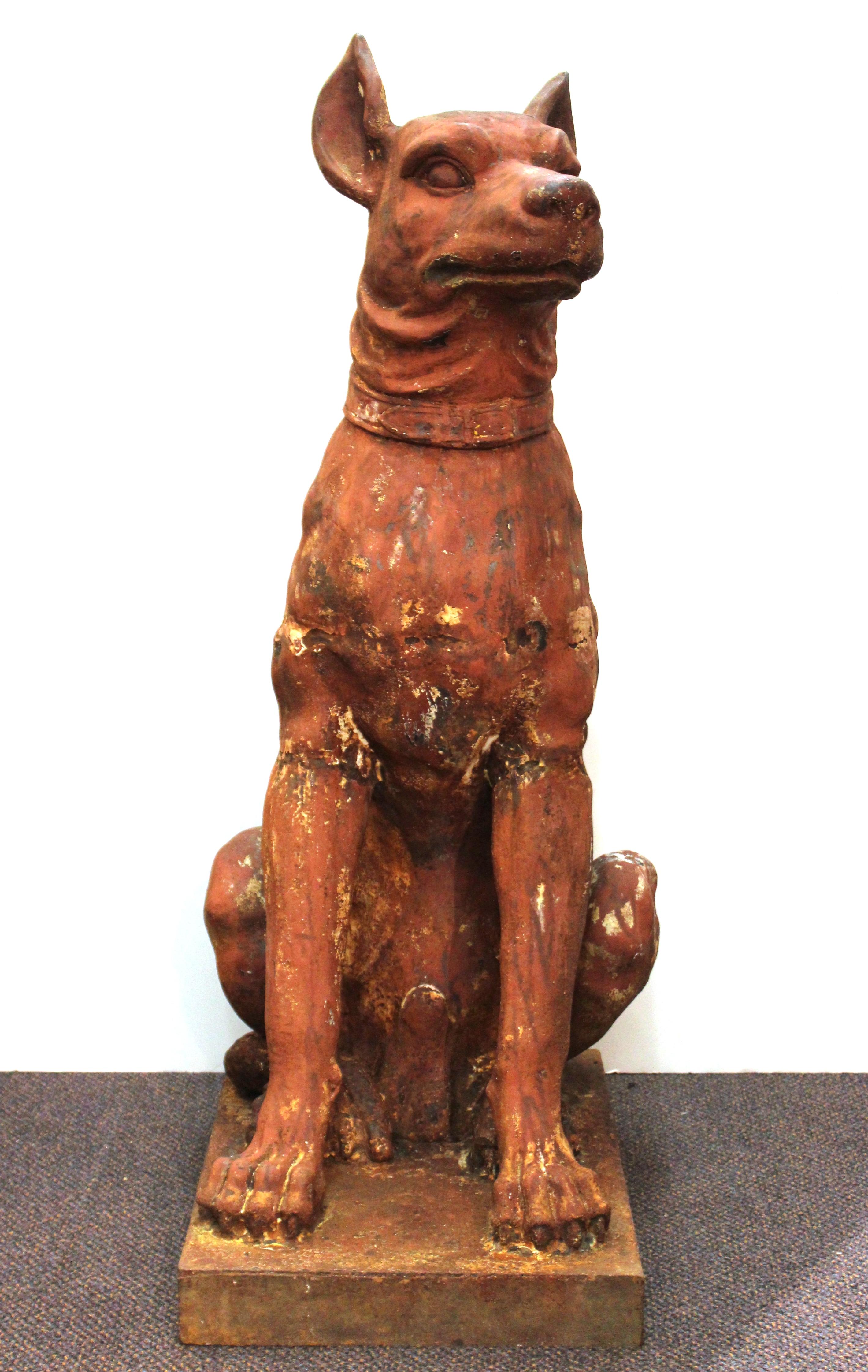 French 19th century pair of beauceron guard dog statues cast in iron, with their original terracotta paint. Frequently used as outdoor garden ornaments or flanking entrance gates. The pair is in great vintage condition, with original weathered
