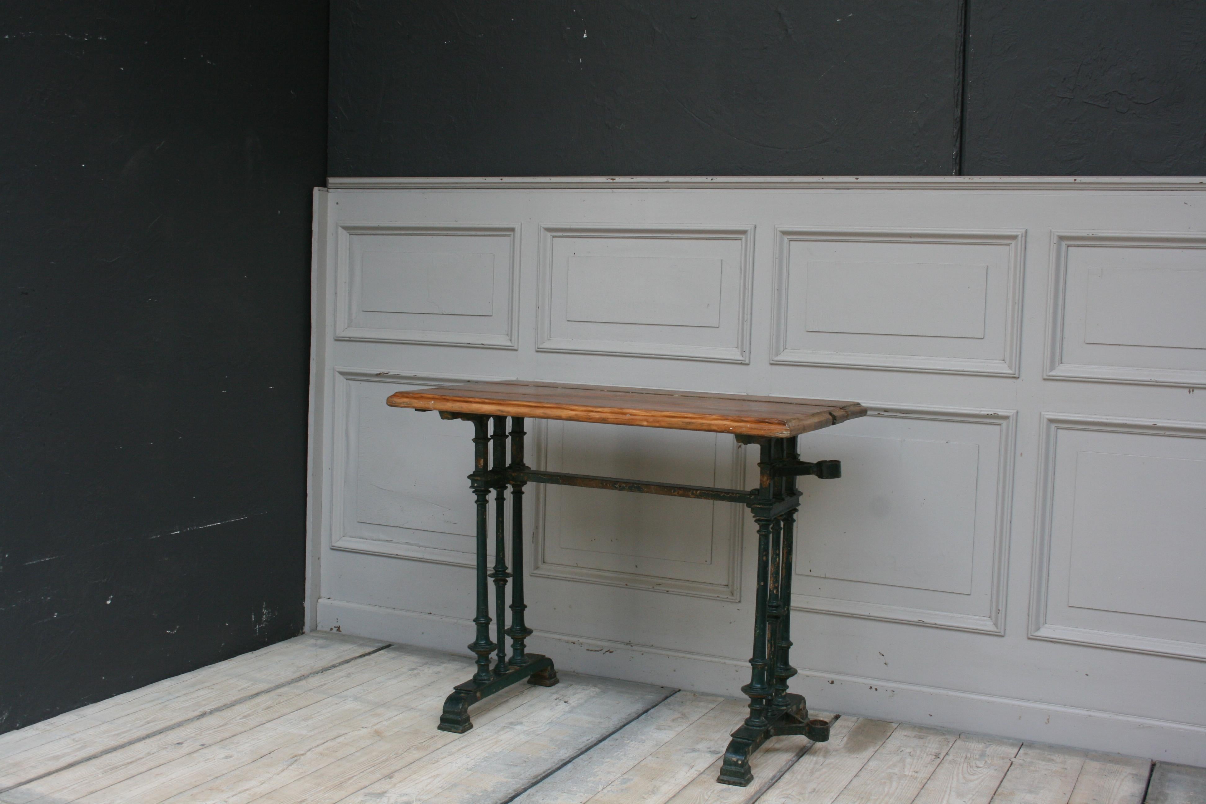 Beautiful 19th century table with cast-iron frame in original paint. The table has a wonderful patina and probably comes from the outside of a bistro in France and has a practical holder for the parasol on the side of the iron frame.
The wood panel