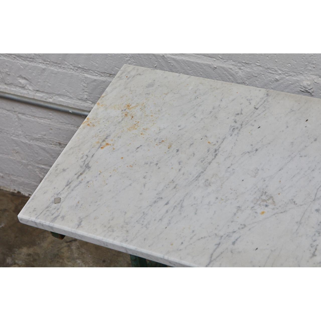 This French cafe table is from the late 19th century. The table has a beautifully designed cast iron base with remnants of the original green paint. The marble top has some additional signs of age and wear including rust spots. 

 



       