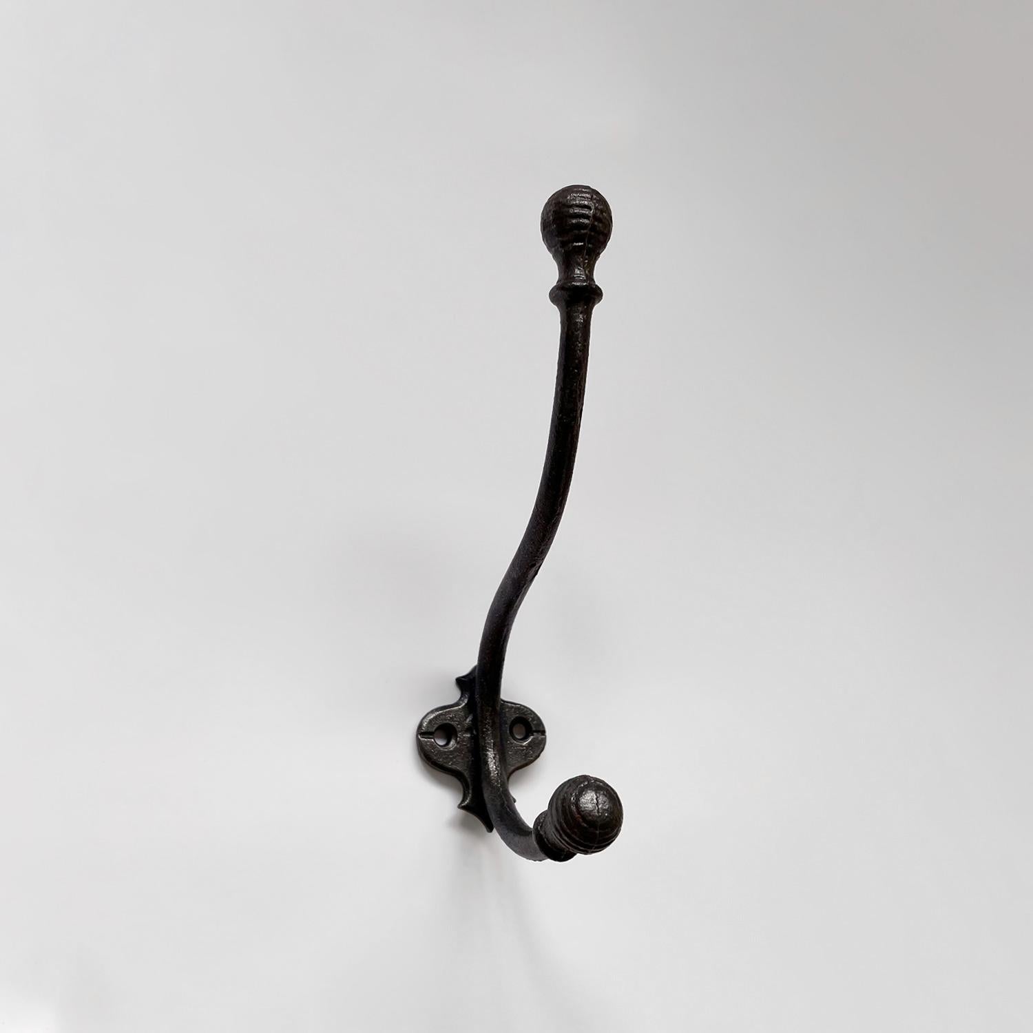 French cast iron double wall hook
France, mid century
Petite in its construction yet charming nonetheless
Curved iron J hook finished with two etched ball hooks providing upper and lower storage
Wall mounted hook is supported by a single bracket