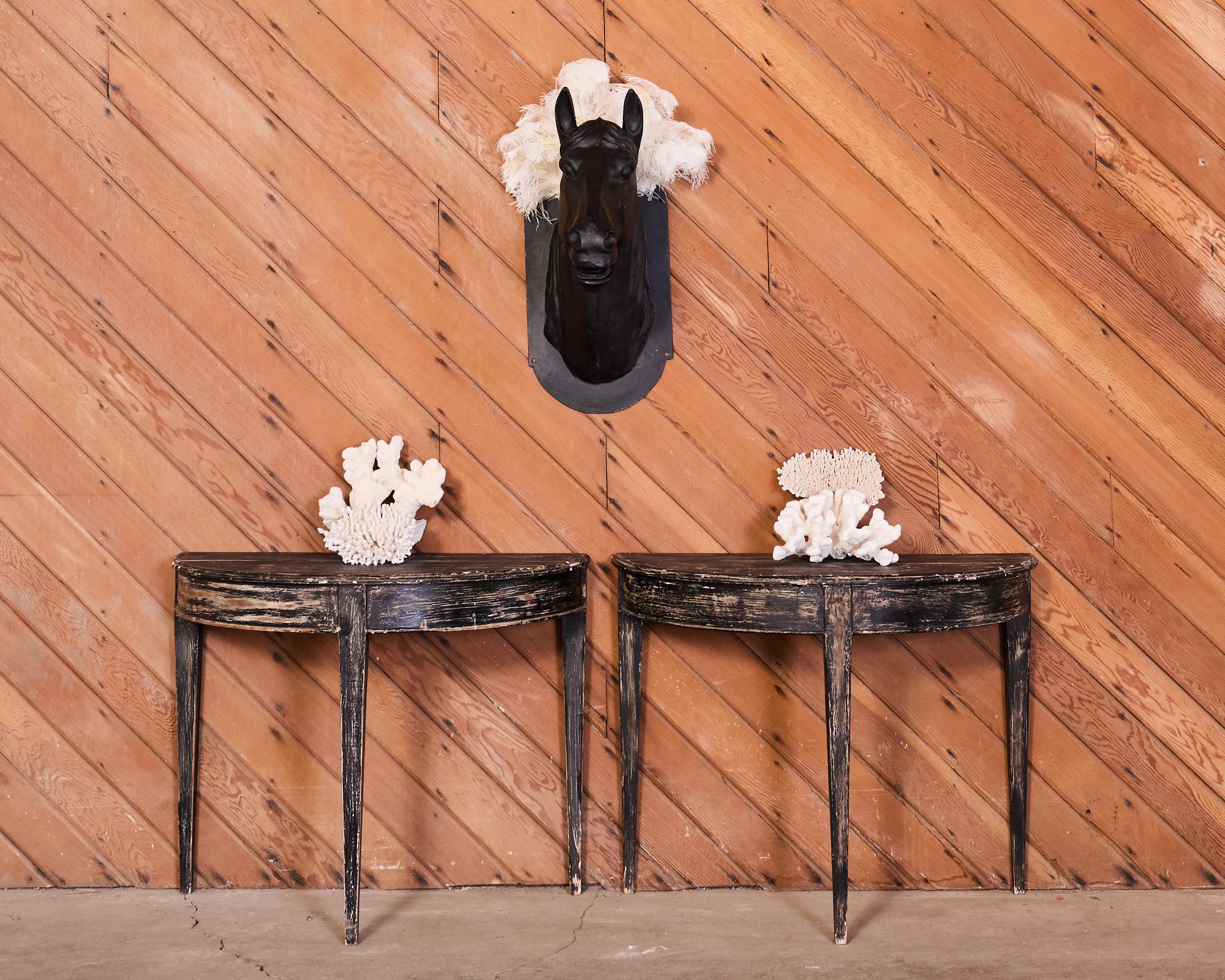 Grand wall mounted sculpture or statue of a French Butcher's Shop trade sign horse head. Constructed from cast iron with a later black painted finish. The horse bust is mounted to a flat plate with H mounting holes. The plate has a decorative arched