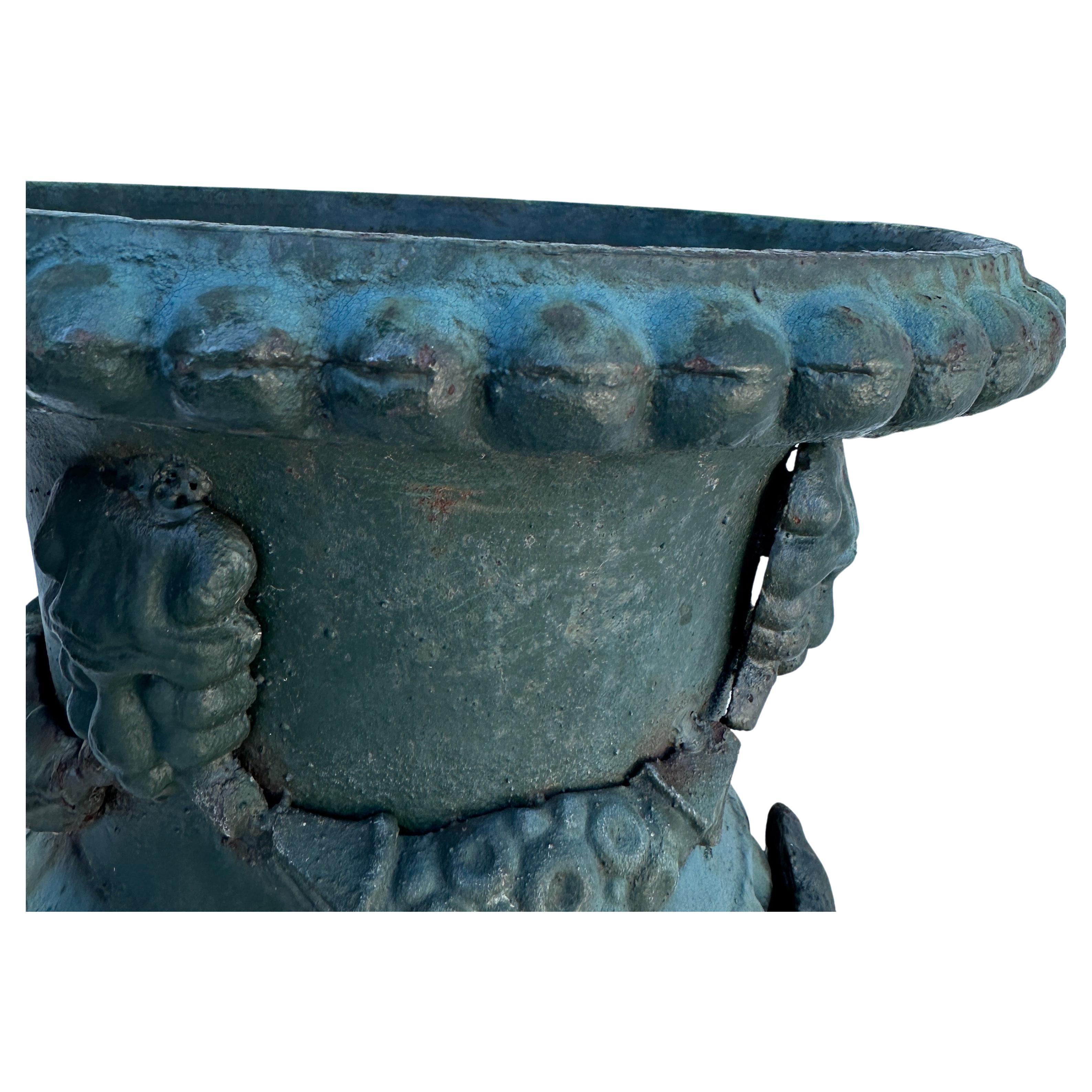 Cast Iron Classical Urn Planter with Handles, France

Exceptional and substantial cast iron piece featuring faces and a relief garland decoration. Wonderful patina and statement piece used indoors or outdoors. 