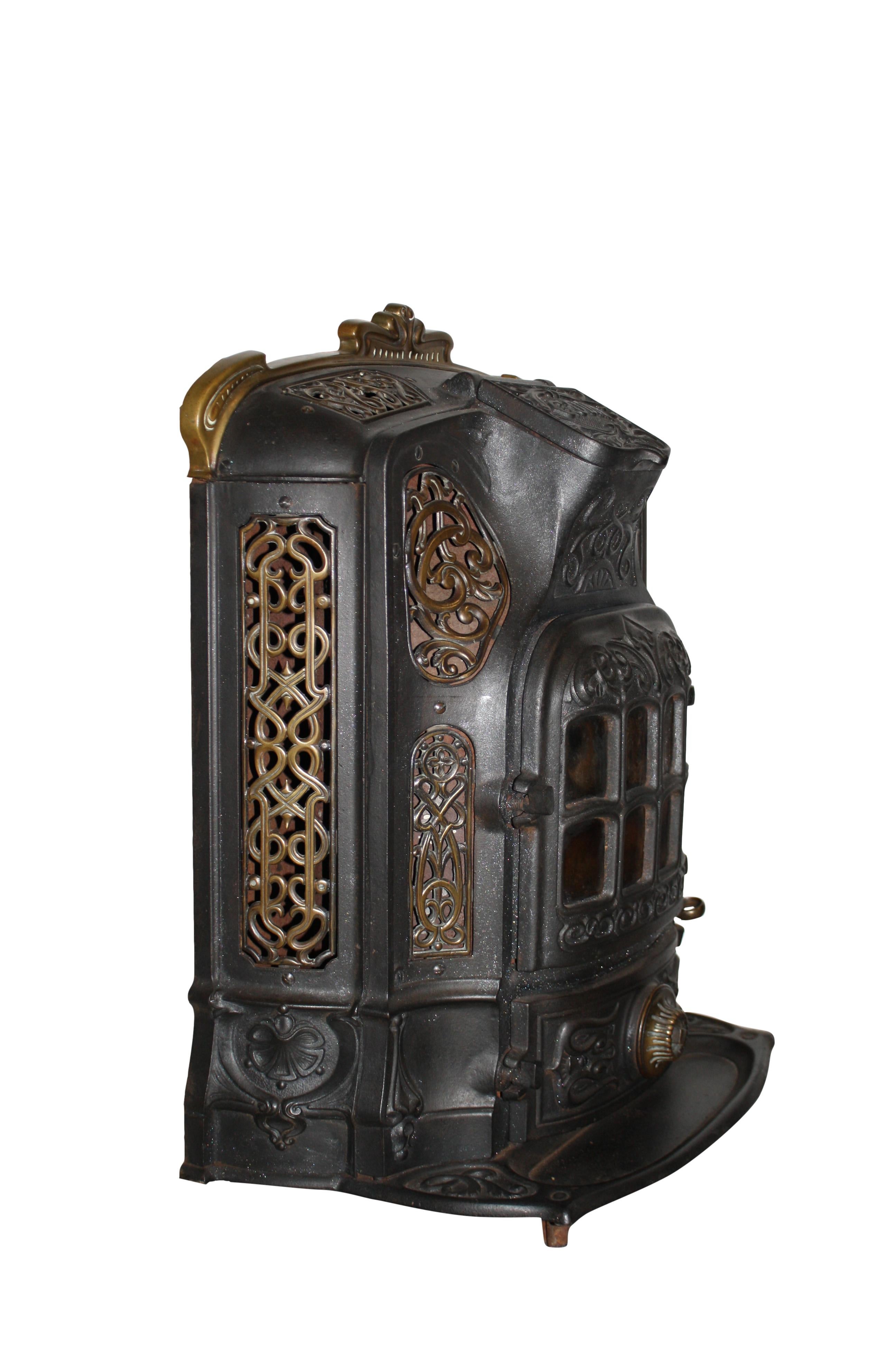 Made in France by the Godin Company, this beauty is a freestanding, multi-fuel, cast iron stove with brass accents and an eight pane, arched door. Godin has been manufacturing stoves in France since 1840. The stove has not been tested.