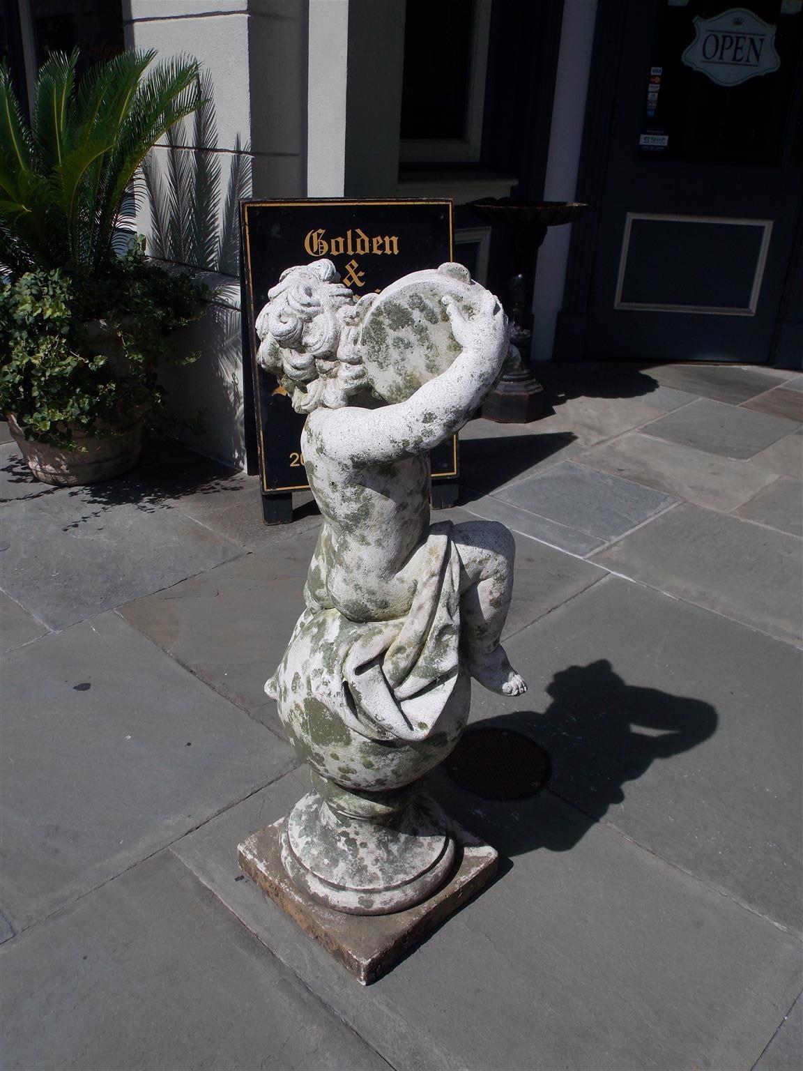 Hand-Crafted French Cast Stone Musical Putti Garden Ornament Seated on Sphere Plinth, C. 1840 For Sale
