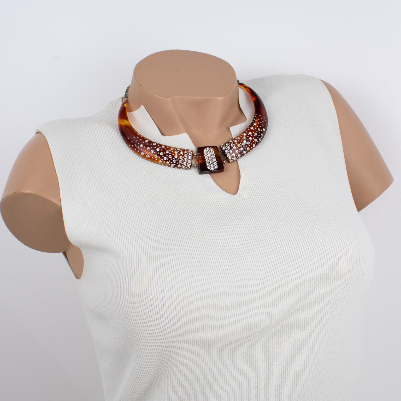 This stunning French celluloid and sparkle choker necklace dates from the 1920s. The piece boasts a faux-tortoise (tortoiseshell) color with a geometric articulated design and is embellished with crystal rhinestones and tiny silvered metal studs.