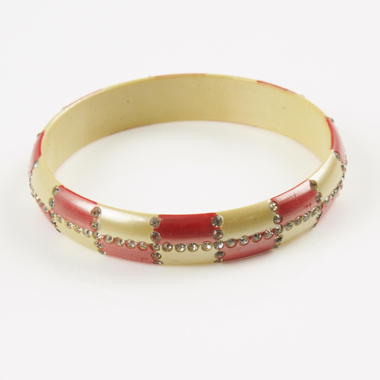 Stunning French celluloid and sparkle bracelet bangle. Pearlized nacre and red colors ornate with geometric checkerboard design made of tiny clear crystal rhinestones. The 1920s flapper style where those bracelets were made to be combined, layered,