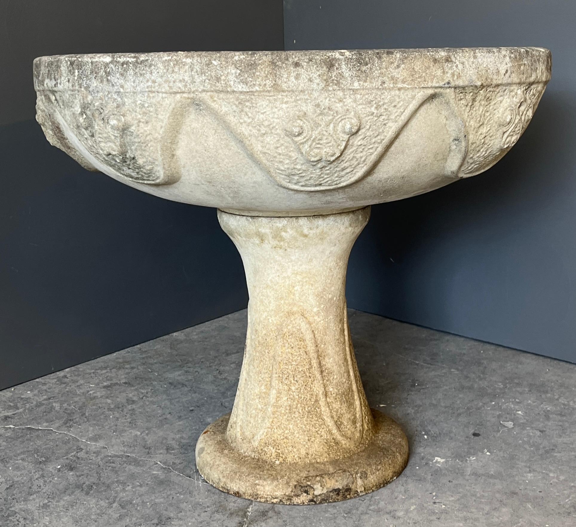 Jardinera francesa con pedestal de la década de 1920, bellamente desgastada, fabricada en cemento con una elegante silueta y detalles delicadamente moldeados. La superficie presenta una rica pátina desgastada por el tiempo: suaves decoloraciones y