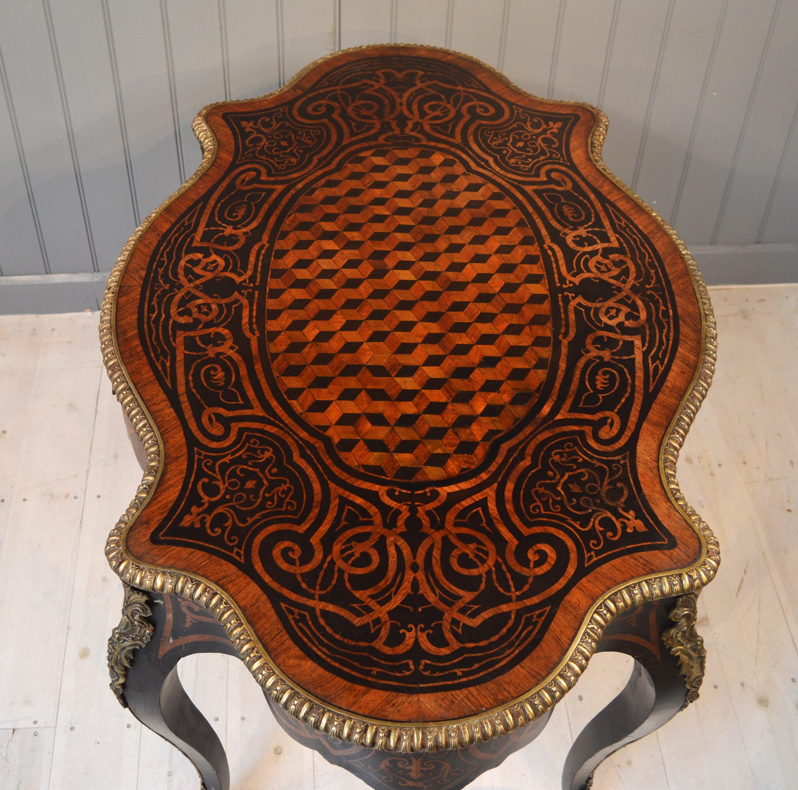 
Good quality French table of unusual form with single drawer and ormolu trim, chequer inlay to the marquetry  top  , the woods are ebony walnut and rosewood and king wood This stunning 19th century centre table or bureau plat is supported on