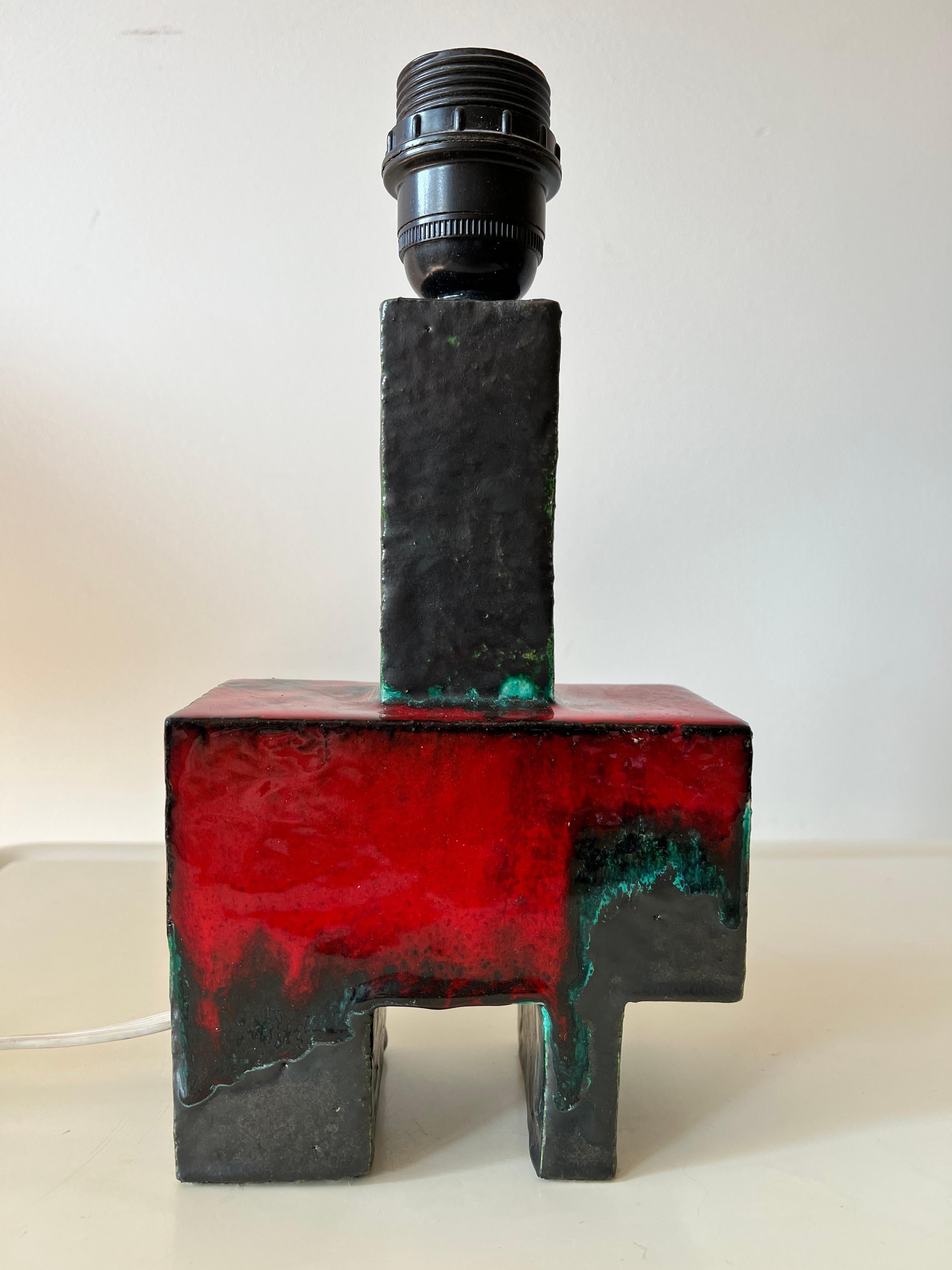 Esthetically pleasing hand crafted ceramic lamp stand (with original shade). Beautifully glazed by a skilled artisan. Interestingly it has typically cubist shapes and vivid colours. Definitely a one off!

We still have the (probably) original