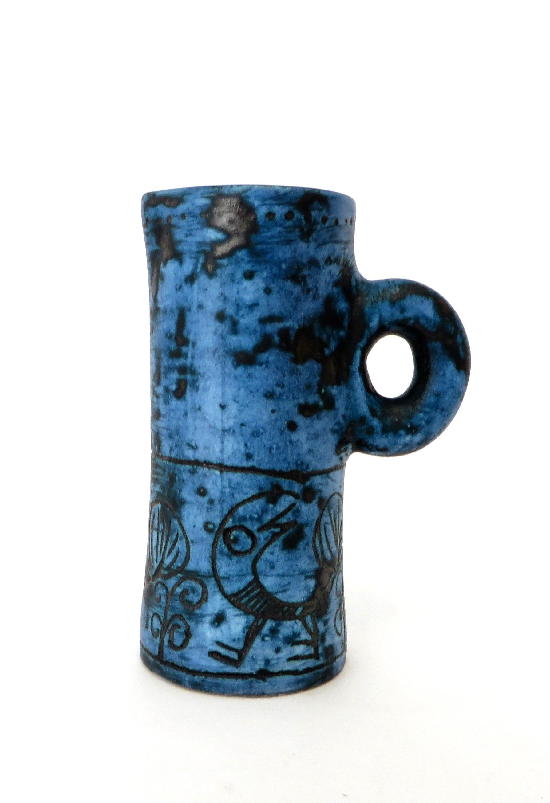A French ceramic pitcher by noted artist Jacques Blin with wonderful image of a bird in his iconic dark blue glaze and sgraffito decoration. No chips or restorations. Signed. 
La Céramique Francaise des Années 50. Pierre Staudenmeyer, pp