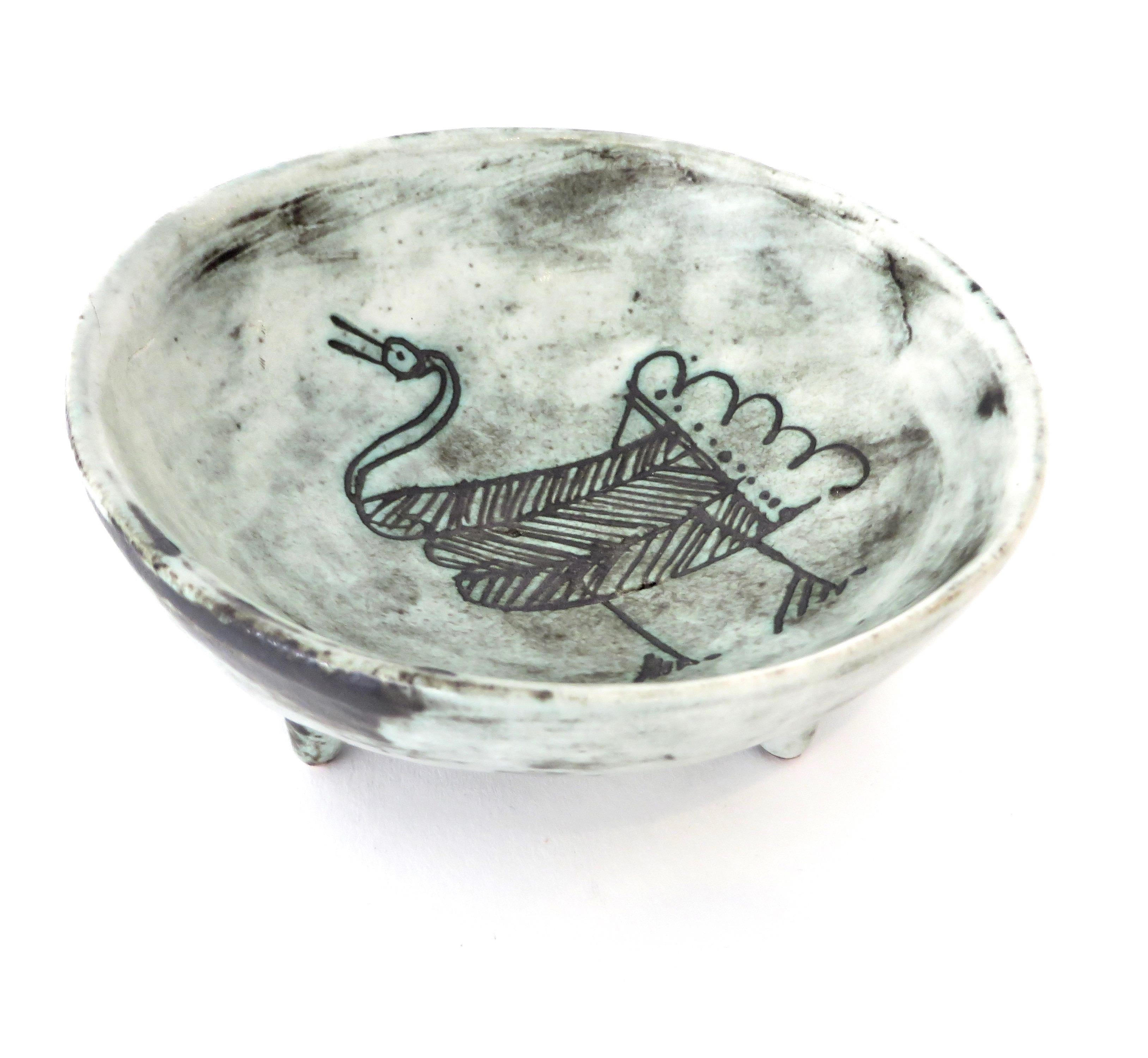 A French ceramic vide poche or small bowl by noted artist Jacques Blin with wonderful image of a bird in his iconic light blue glaze and sgraffito decoration. No chips or restorations. Signed. 
Part of a nice collection and each piece is listed