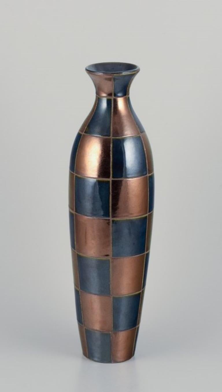 French ceramic artist. 
Large unique ceramic vase in a modernist design.
Square sections in blue and gold-tone glossy glaze.
Mid-20th century.
Perfect condition.
Dimensions: Height 47.5 cm x Diameter 13.0 cm.