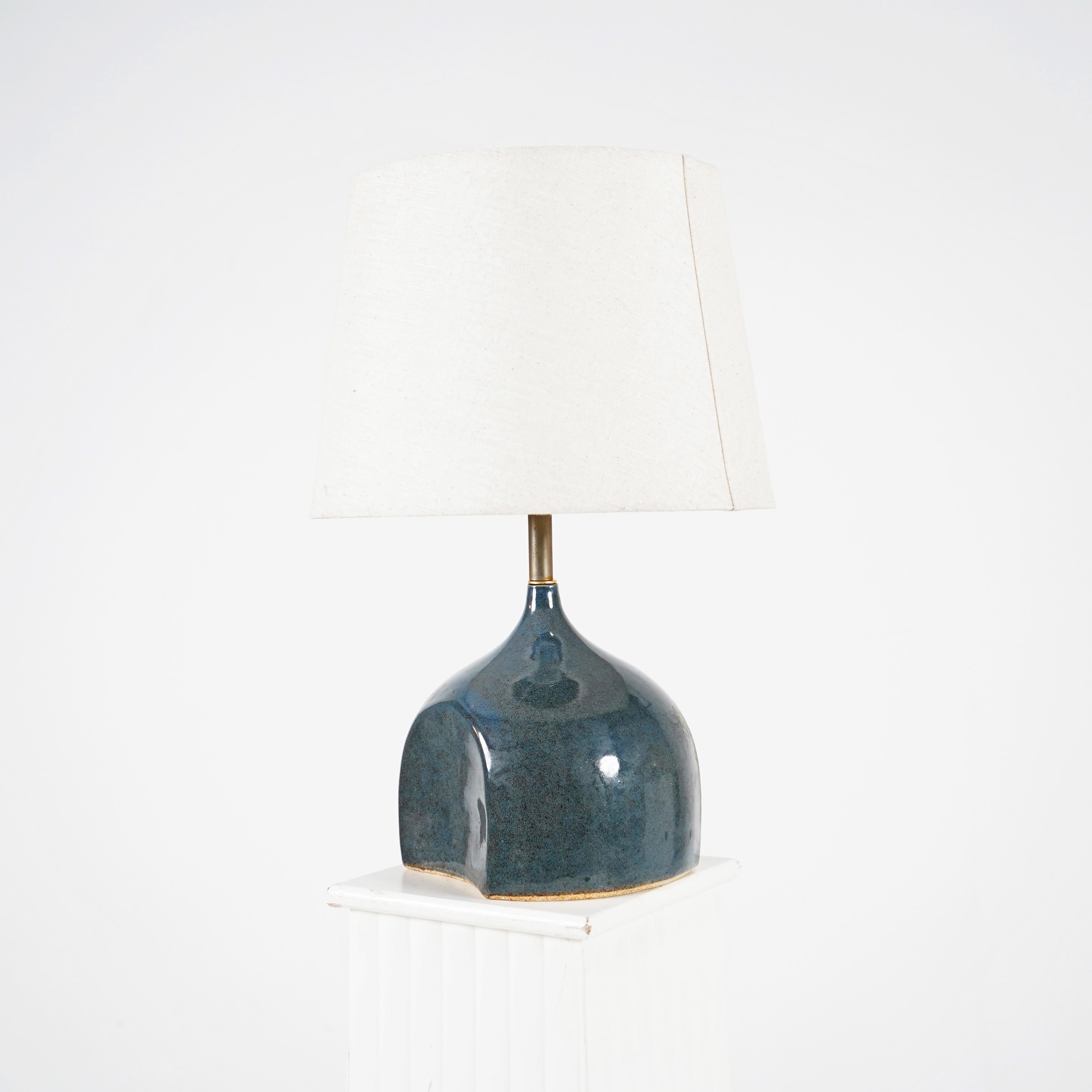 This stylish vintage French studio ceramic lamp is the perfect addition to any home. Adorned with a beautiful blue glaze and stylish design. Makers mark on the base. Rewired and PAT tested, this lamp will brighten up your home in no time. Shade is