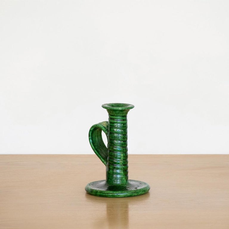 Lovely vintage ceramic candlestick holder with deep green glaze and loop handle, from France.