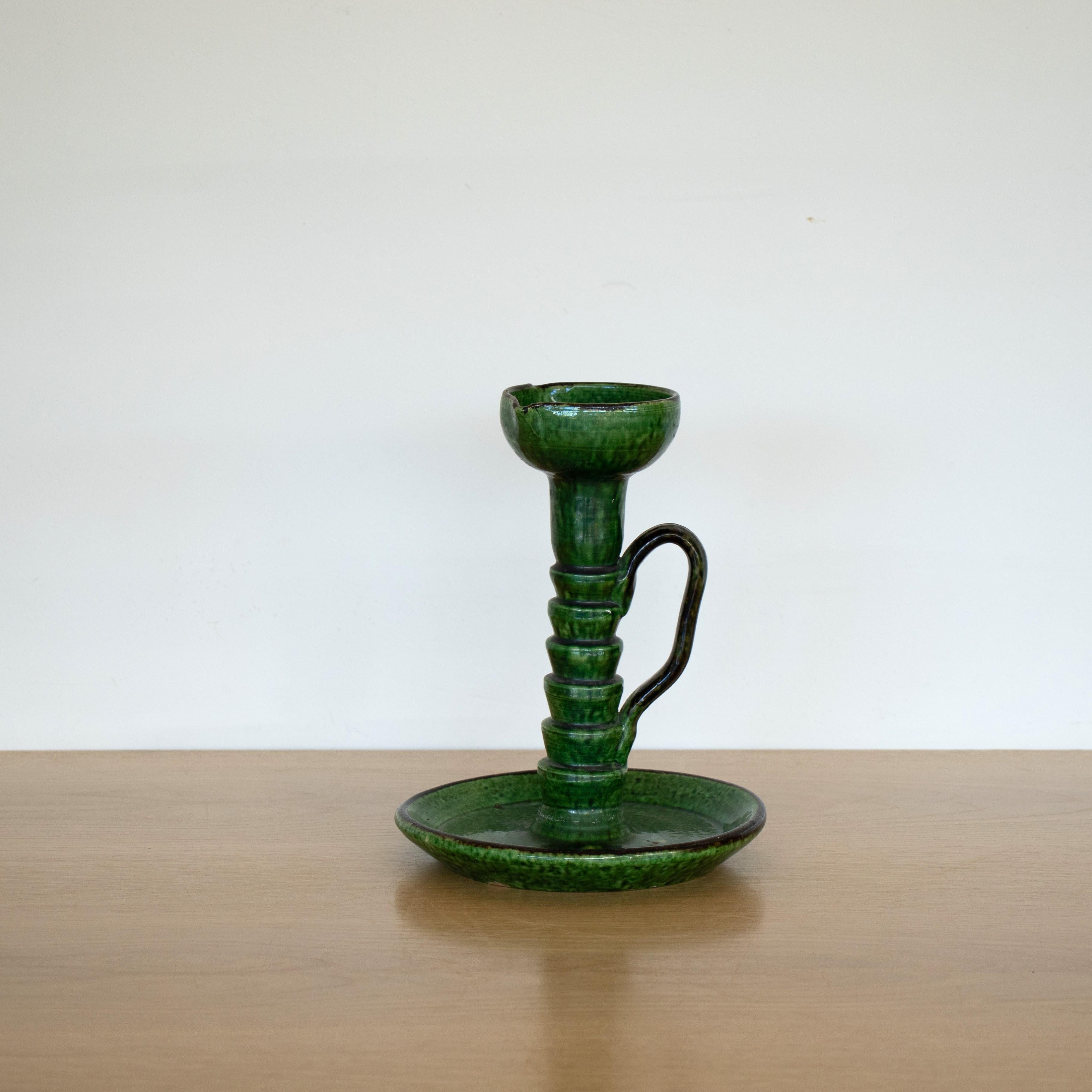 Lovely vintage ceramic candlestick holder with deep green glaze and loop handle, from Vallauris, France.