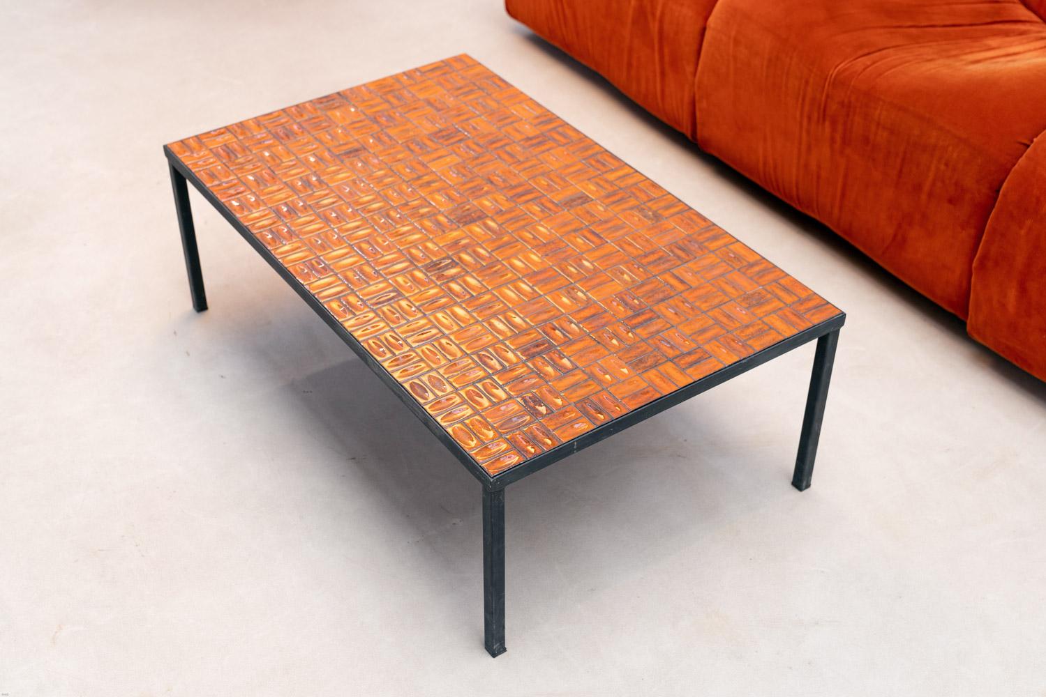French coffee table covered with orange ceramic on a black metal frame.
A nice touch of '60s color  for your interiors.

Do not hesitate to contact us for any additional information. We would be more than delighted to assist you in any way we can.