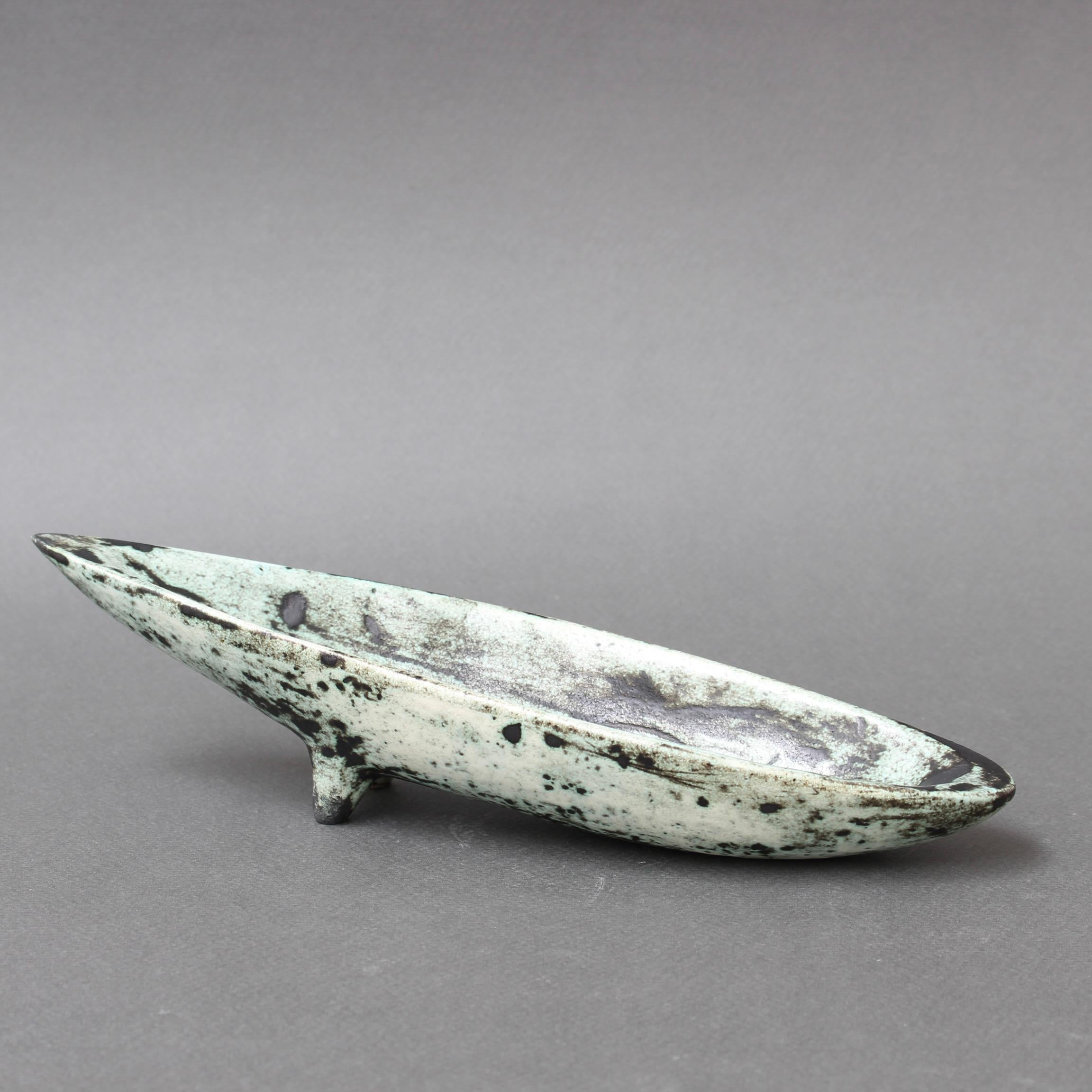 French vintage ceramic, canoe-shaped dish by Jacques Blin (circa 1965). Blin's trademark cloudy glaze surrounds a sgraffito image of a bird - seemingly from an undiscovered primeval cave - which is featured in the centre of the dish. Whimsically