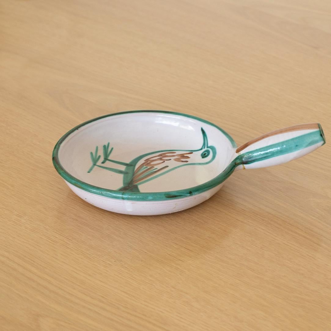 Incredible hand painted ceramic dish with handle by French ceramic artist Robert Picault from the 1960's. Vibrant green and brown colors painted on white ceramic with a bird motif. Signed.