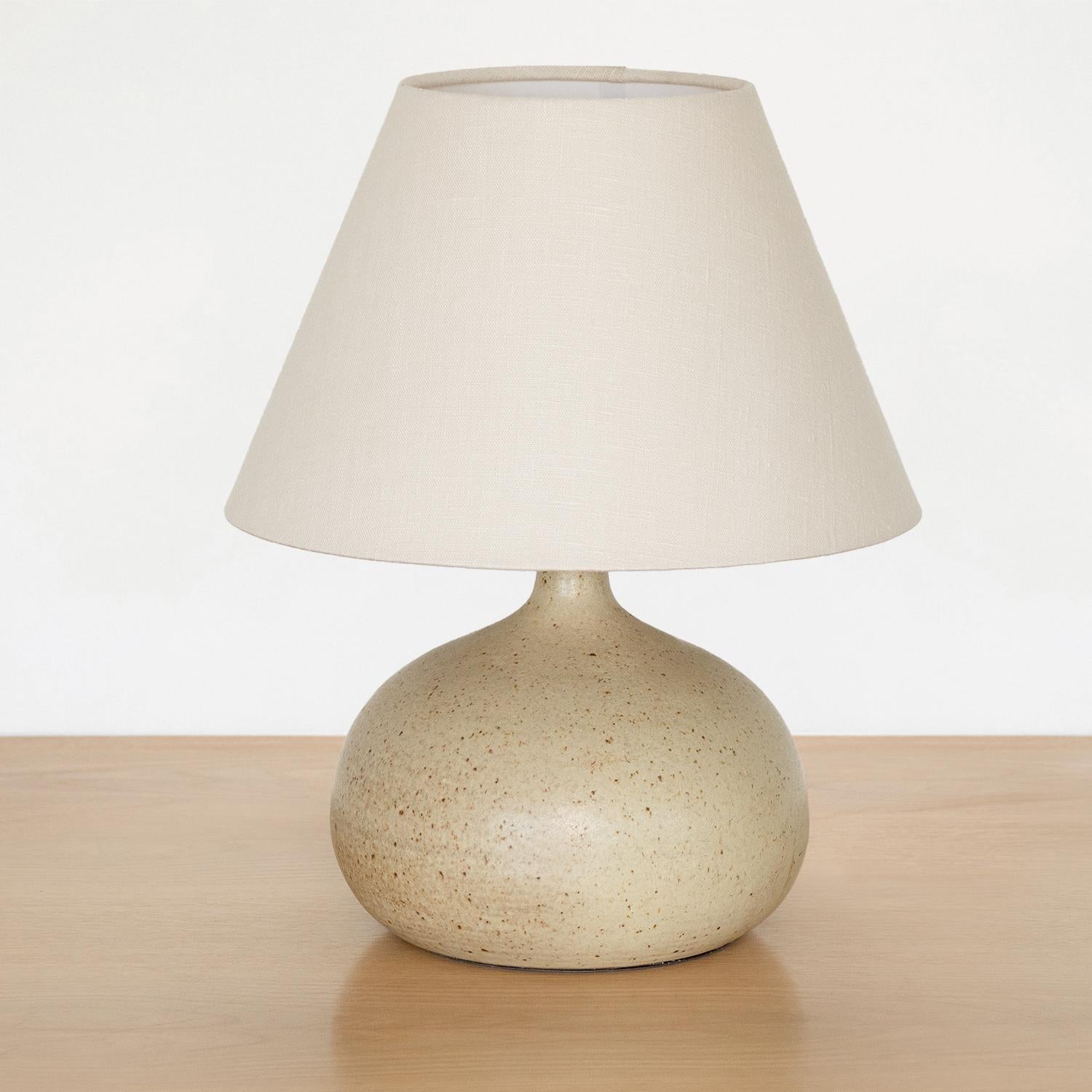 Vintage ceramic bulbous lamp from France, 1960s. Matte glazed ceramic base in neutral tones with light brown speckled coloring. Newly rewired with new tapered linen shade.
