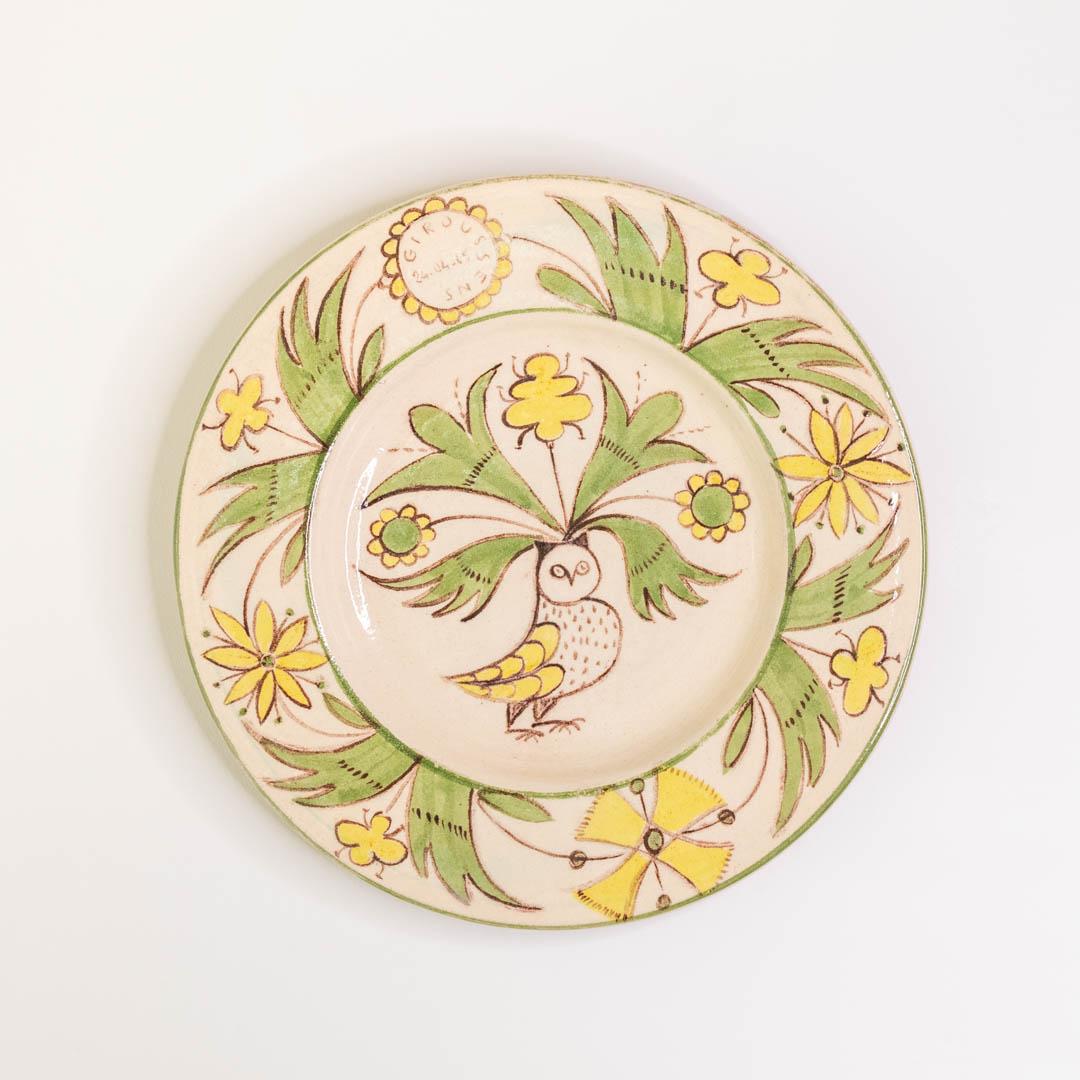 Beautiful painted ceramic plate from France, 1960's. Delightful floral motif with owl. Green, yellow and brown hues painted on cream glazed plate. Great hung on the wall as decorative art. 
 