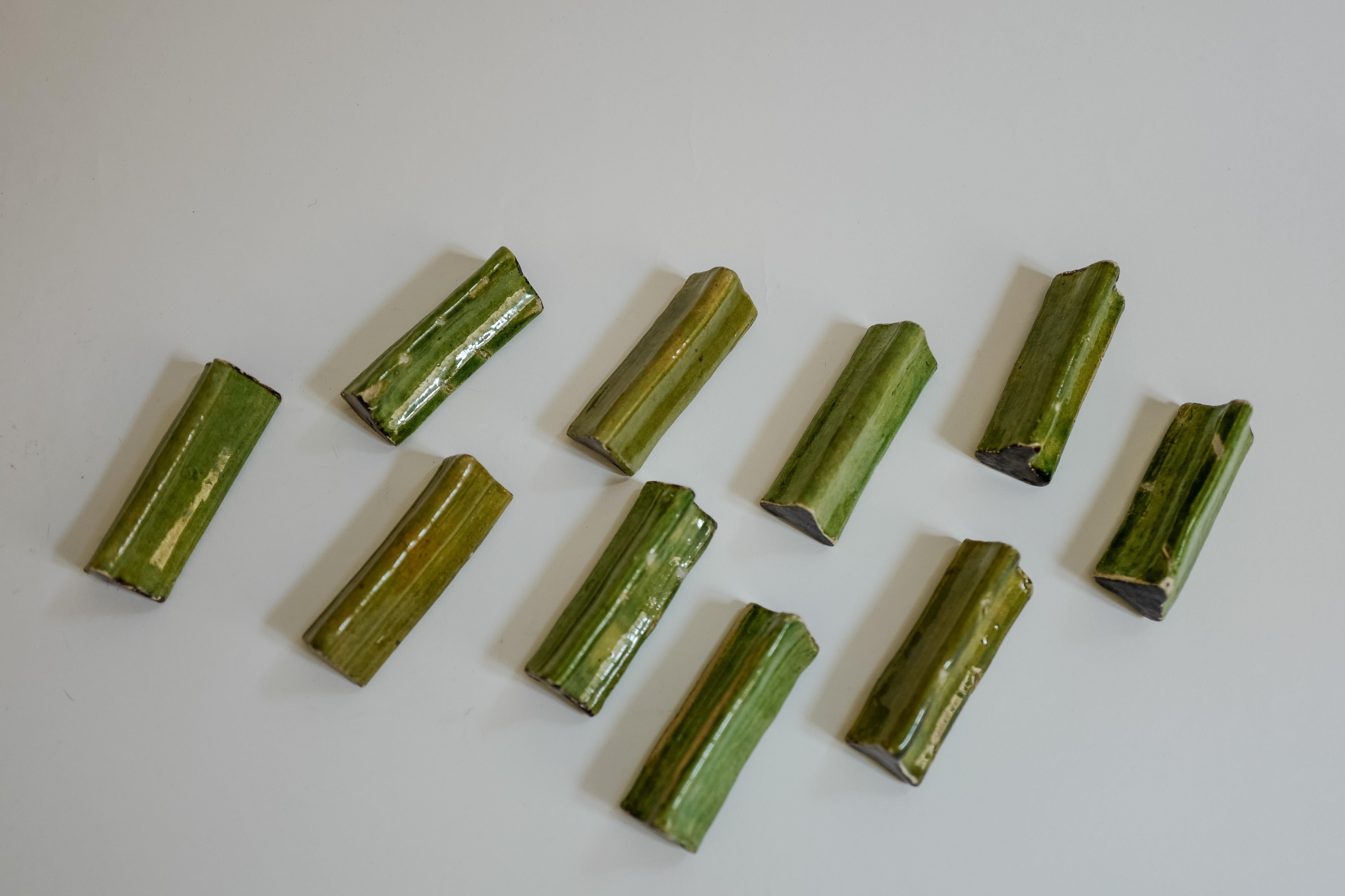 A set of 10 French ceramic green glaze knife rests. From Provence.