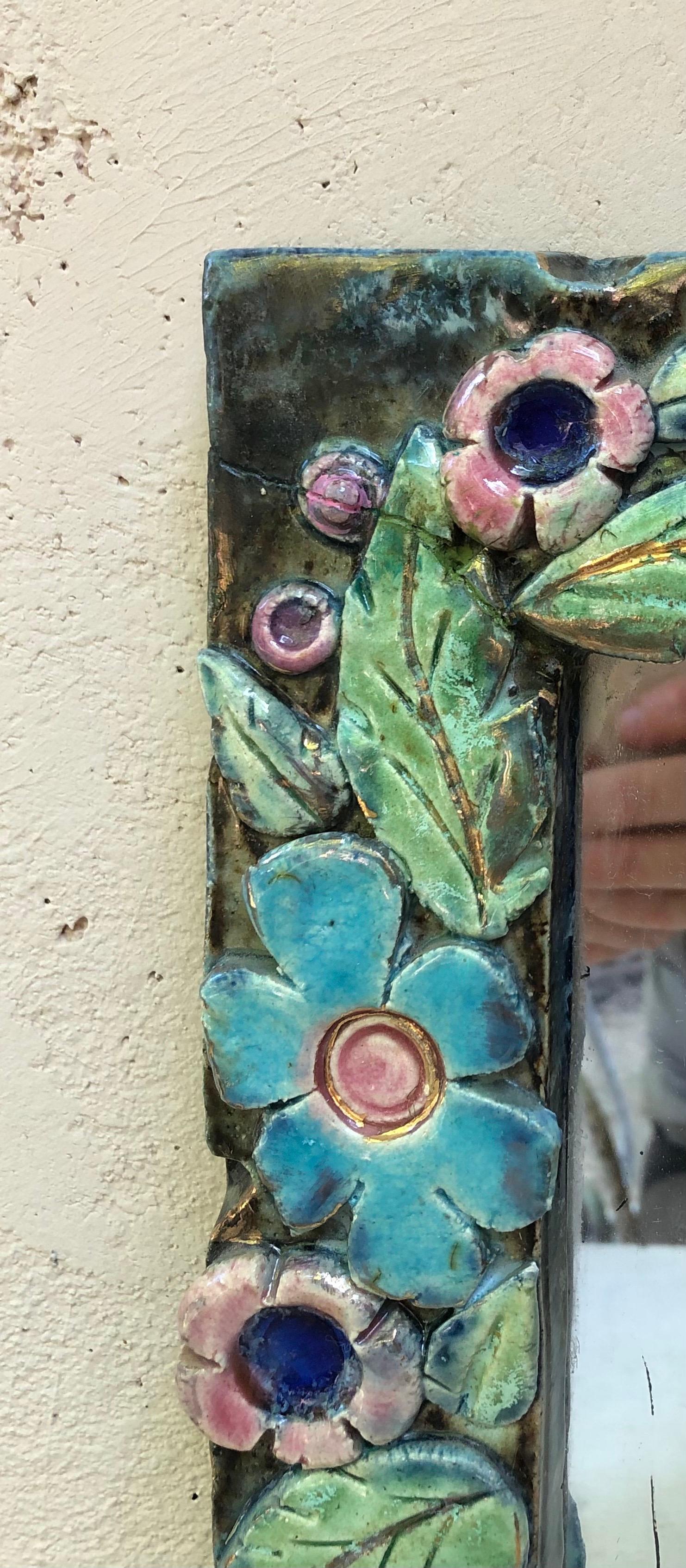 French ceramic mirror Lembo, Circa 1950.
Decorated with aqua and pink flowers with iridescence and gold highlights.