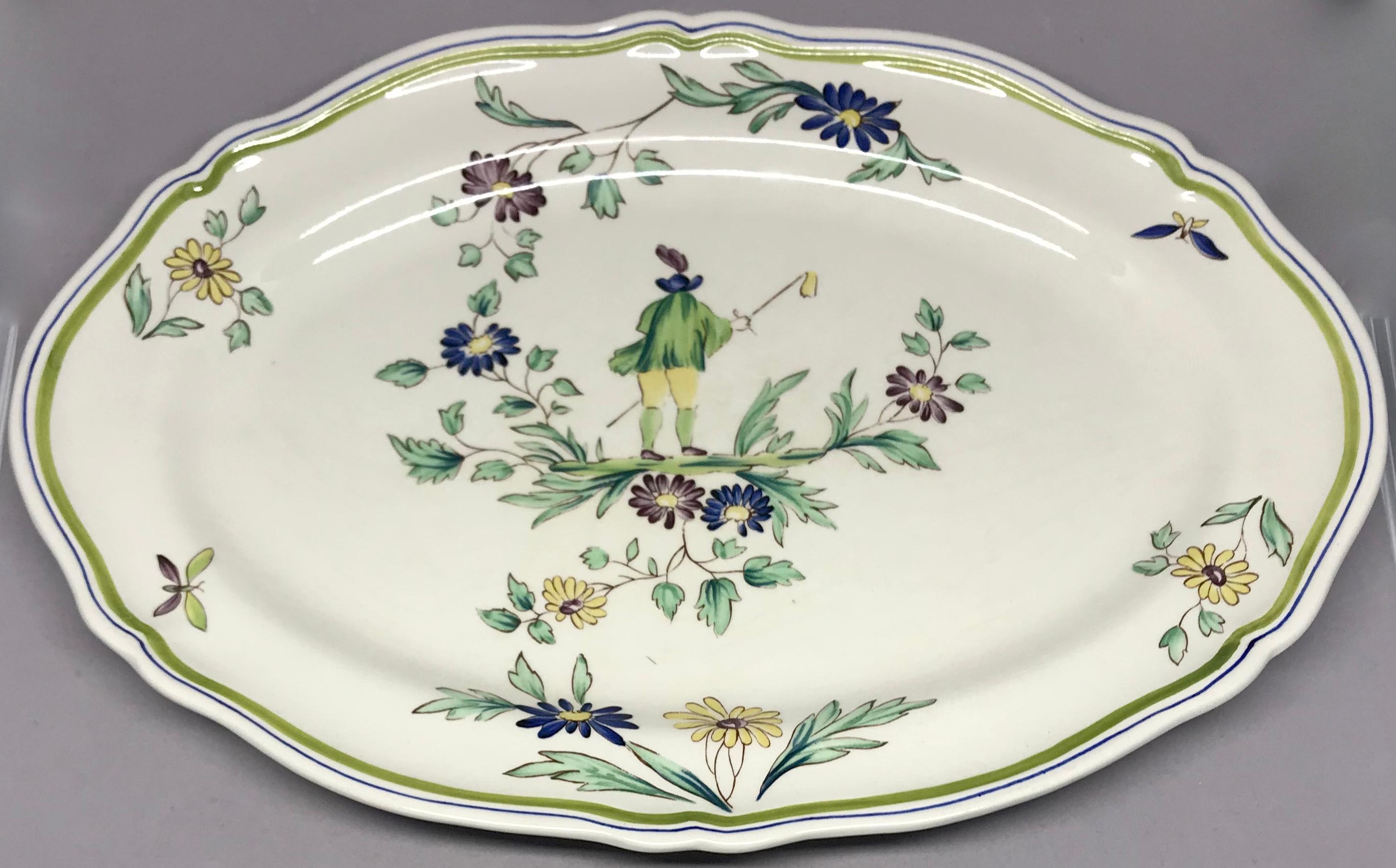 French ceramic painted chinoiserie platter. Vintage Longchamps shaped oval platter with hand painted figure amongst flowers and butterflies. France, mid-20th century.
Dimensions: 14