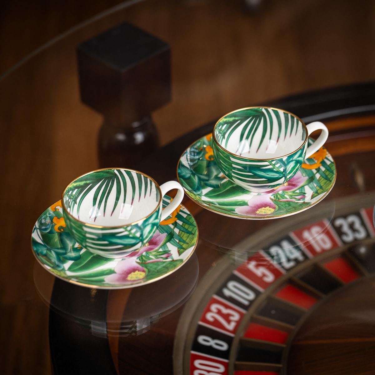 Hermès, Passifolia Breakfast Cup and Saucer in Porcelain. These exquisite pieces feature decorations that are screen-printed and meticulously applied by hand using 24-carat gold thread. Passifolia, positioned at the intersection of botanical