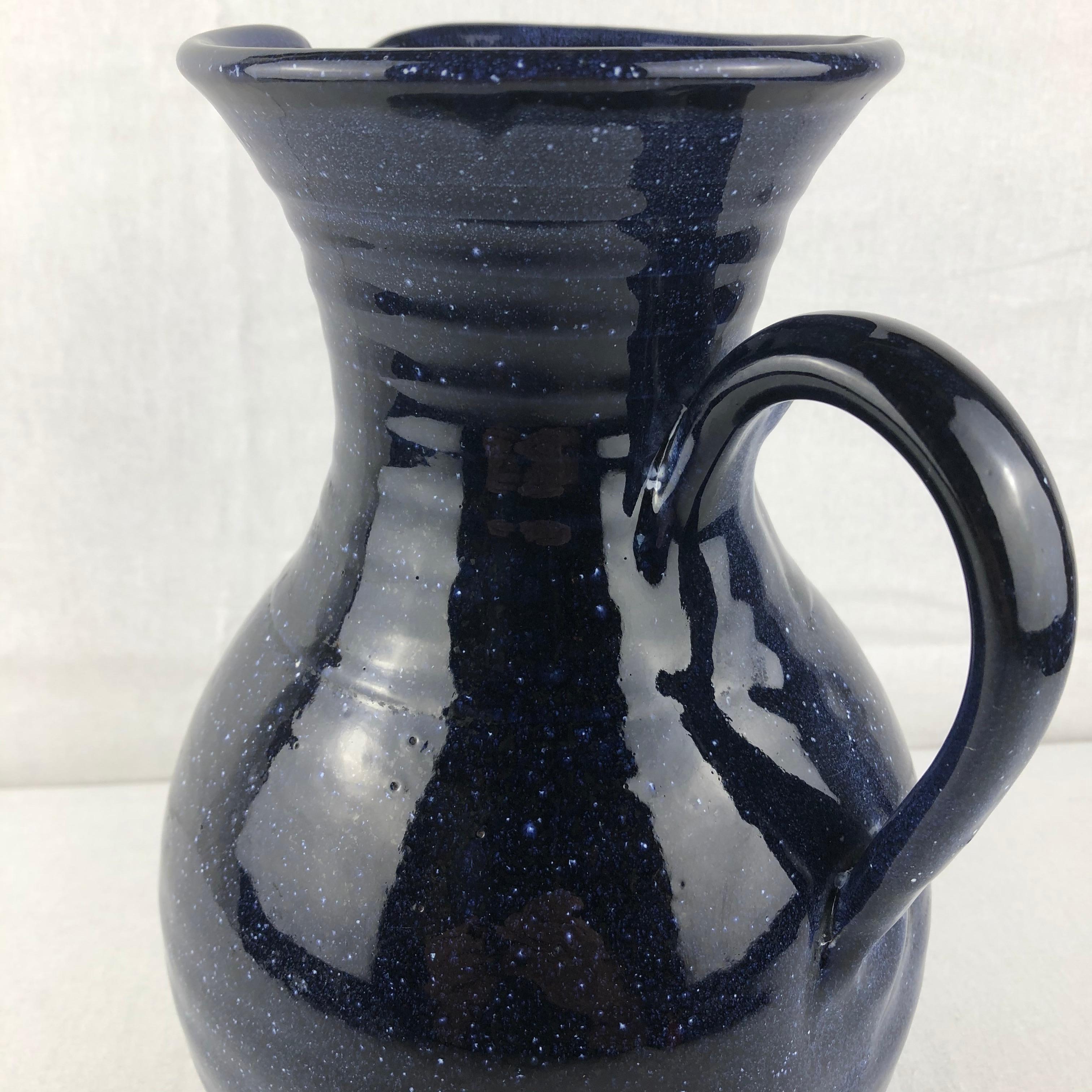 Beautiful hand-crafted mid- 20th Century handled vase or pitcher from Anduze. This eye-catching decorative object is in perfect condition and will enhance any table, countertop or shelf. 

Perfect with almost any color scheme. Color is a dark blue