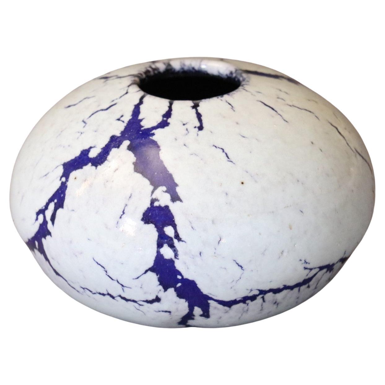 French ceramic ball vase by Marc Uzan - circa 2000
Delicate enamelling in white and violet tones - Ring neck
Signed under the base
Very good condition

--------------------------
Born in Sousse, Tunisia in 1955, Marc Uzan discovered modelling