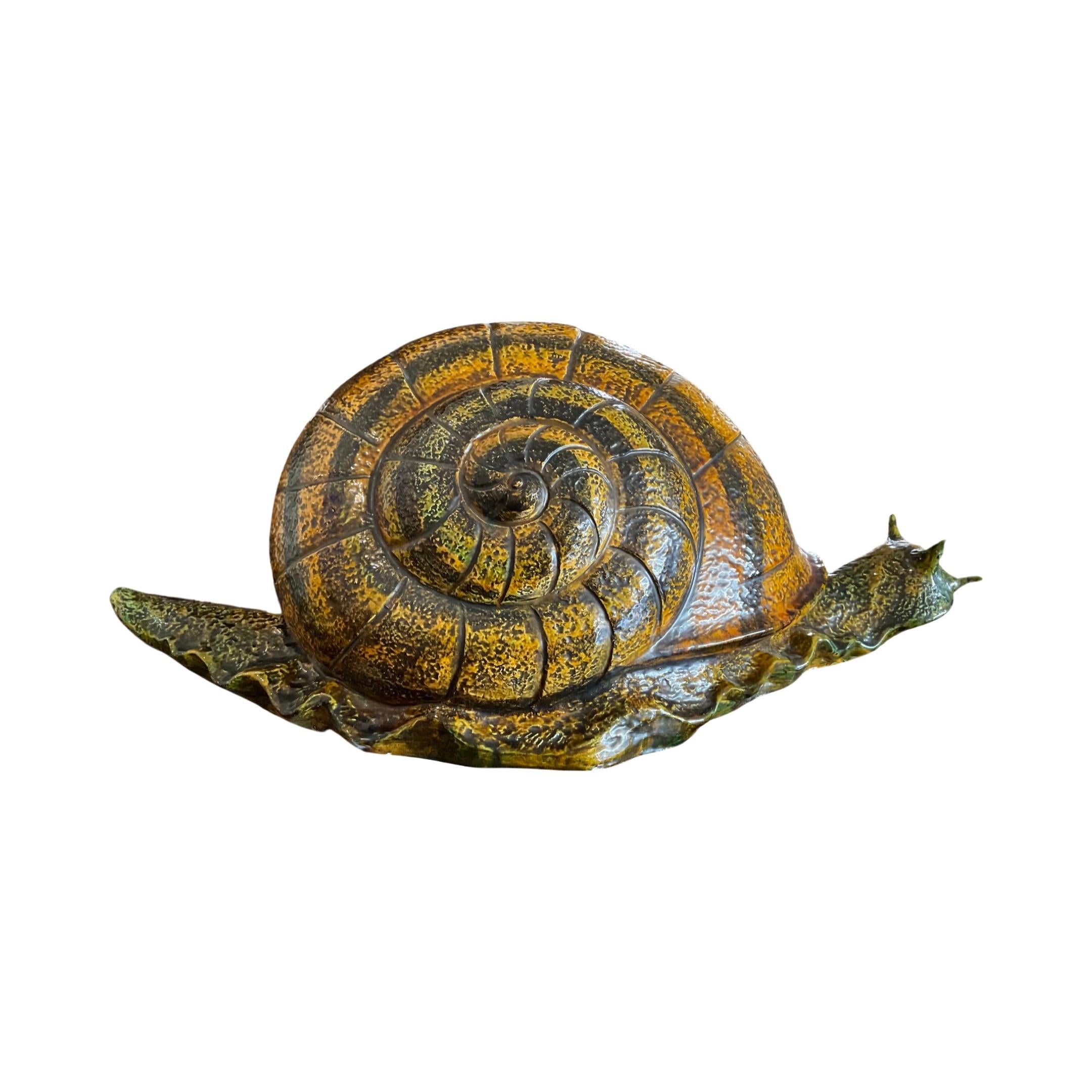 This 19th-century French snail sculpture is a unique piece of art, crafted from a ceramic composite with a glazed finish. Its rustic charm is sure to bring a special touch to your space, making it a perfect addition to any interior.
