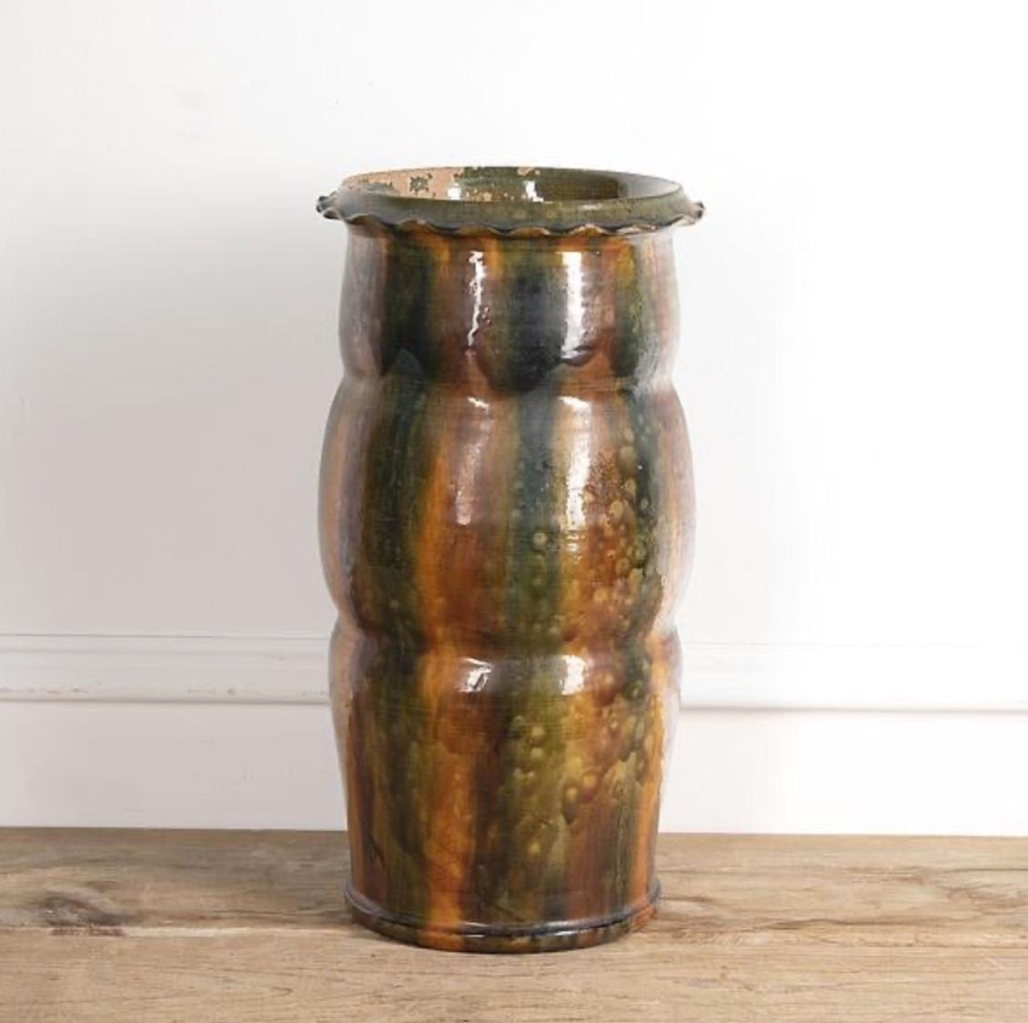 19th century ceramic stick stand with persimmon and moss toned drip glaze from a studio pottery workshop in France. The organic shape and soft glazing technique gives this versatile piece a lovely rustic feel. 

France, circa 1890

Dimensions:
